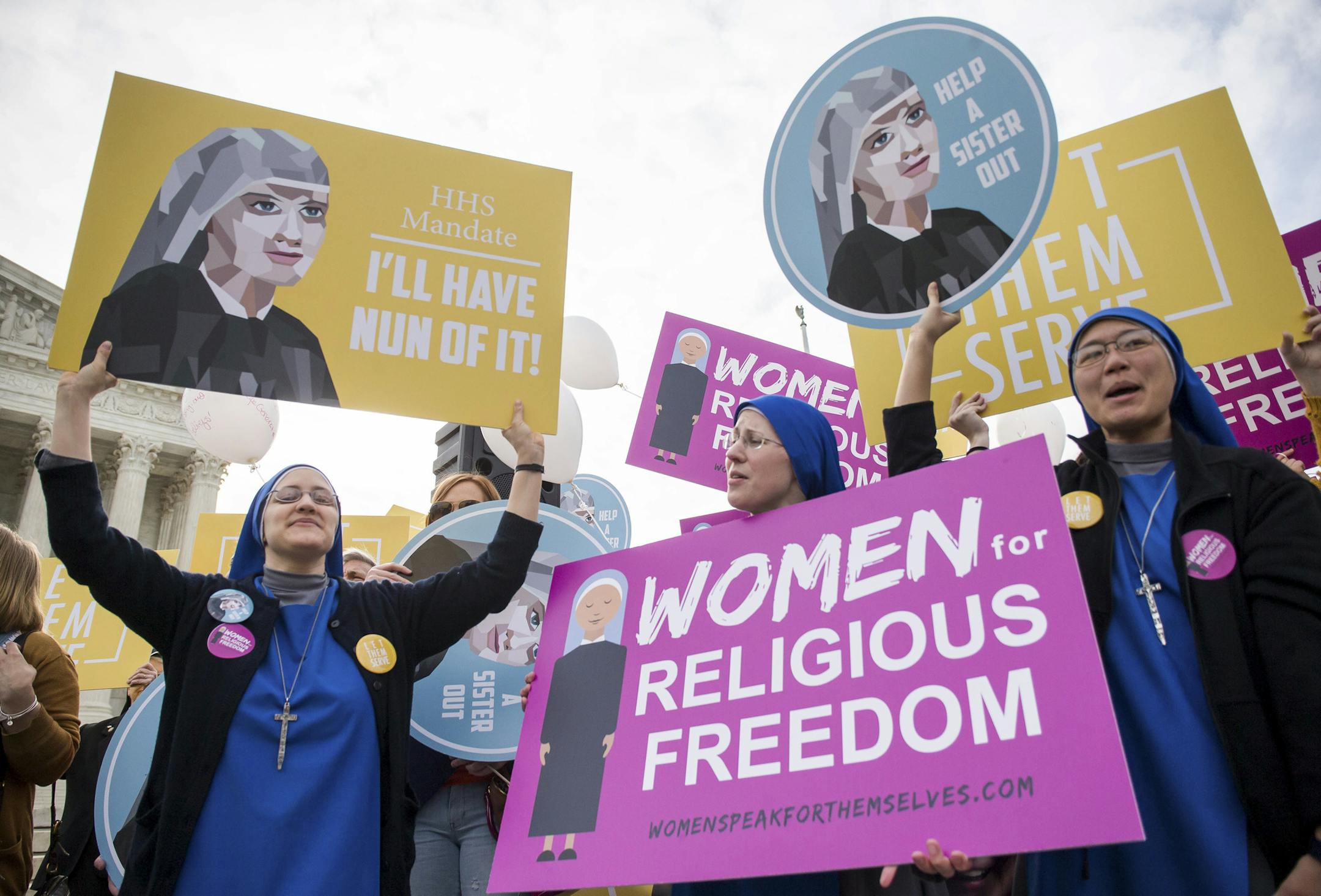 Demonstrators hold signs outside U.S. Supreme Court, which was hearing arguments for the case Zubik v. Burwell, in Washington, March 23, 2016. The court returned Wednesday to the question of whether a regulation requiring many employers to provide free contraception coverage for their workers under the Affordable Care Act violates a federal law protecting religious freedom. (Zach Gibson/The New York Times)
