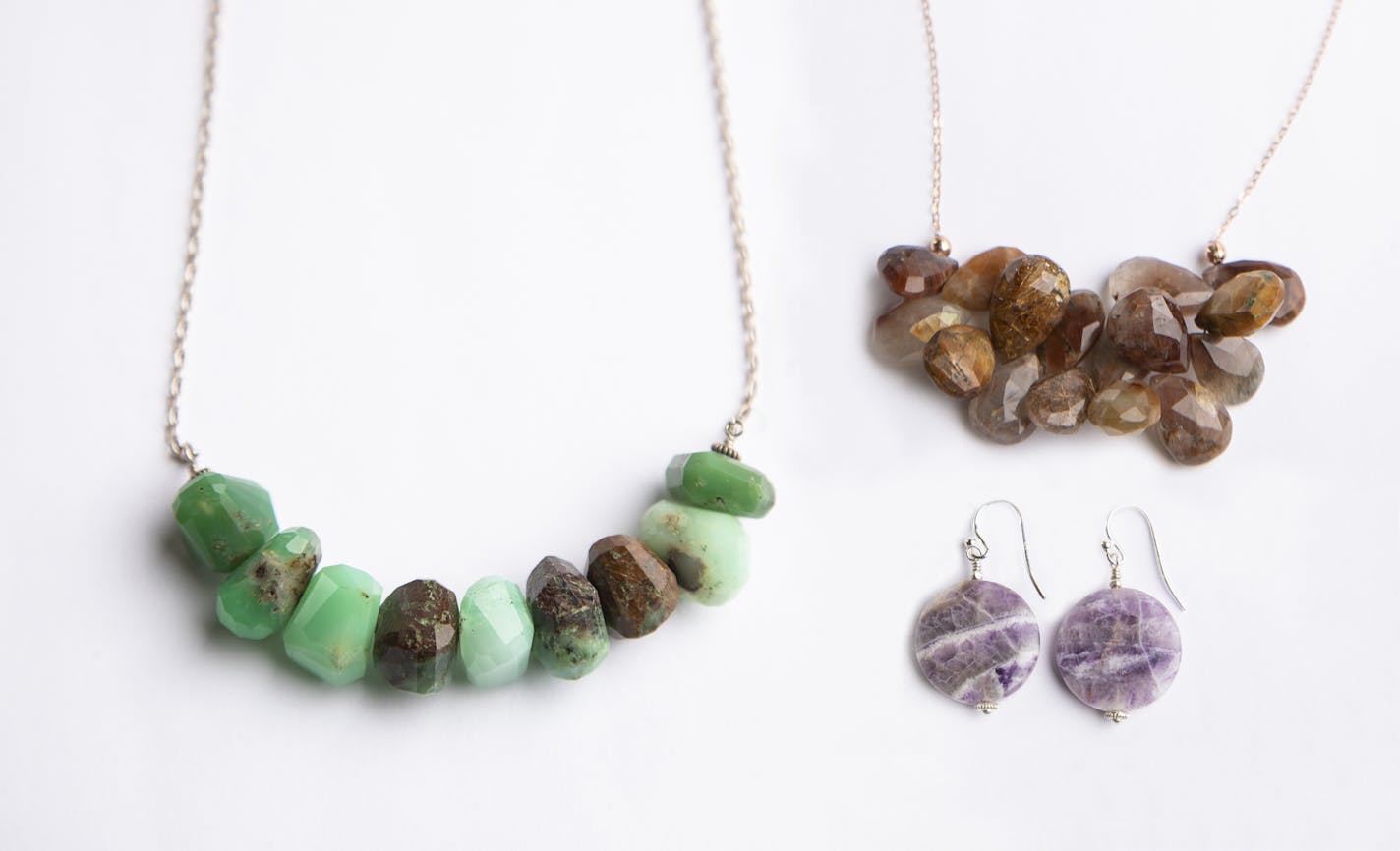 Kaleidescope Kitty: Green chrysoprase necklace $189, copper rutilated quartz necklace $60; Charoite earrings $30.