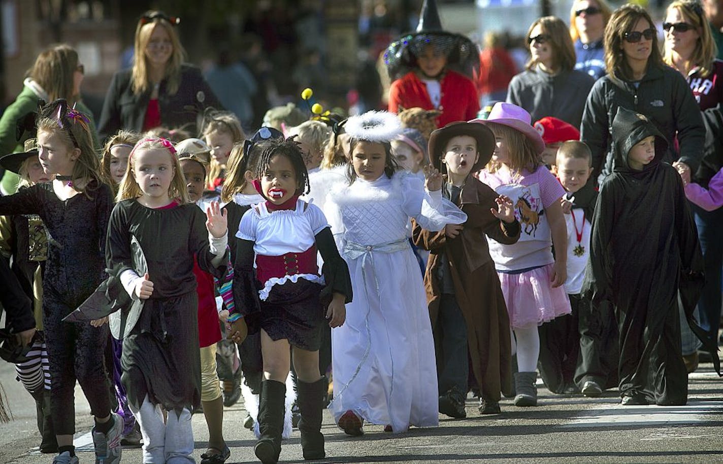 Elementary school students waved to spectators along the parade route as they walked along Main St. in Anoka