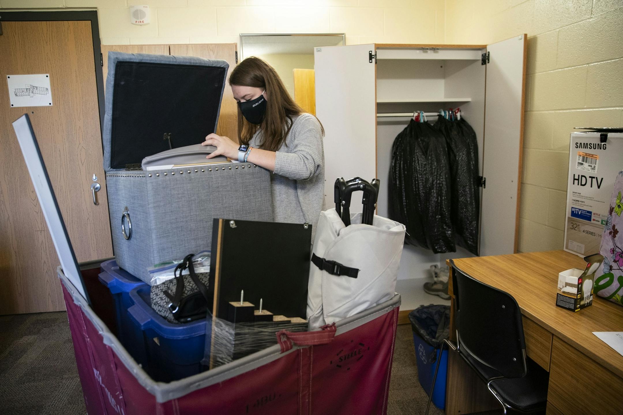 Riley Krenz, an freshman Chemistry major from Rosemount, MN, began unpacking the first of three carts with her belongings as she moved into her room in Ianni Hall at UMD on Thursday.