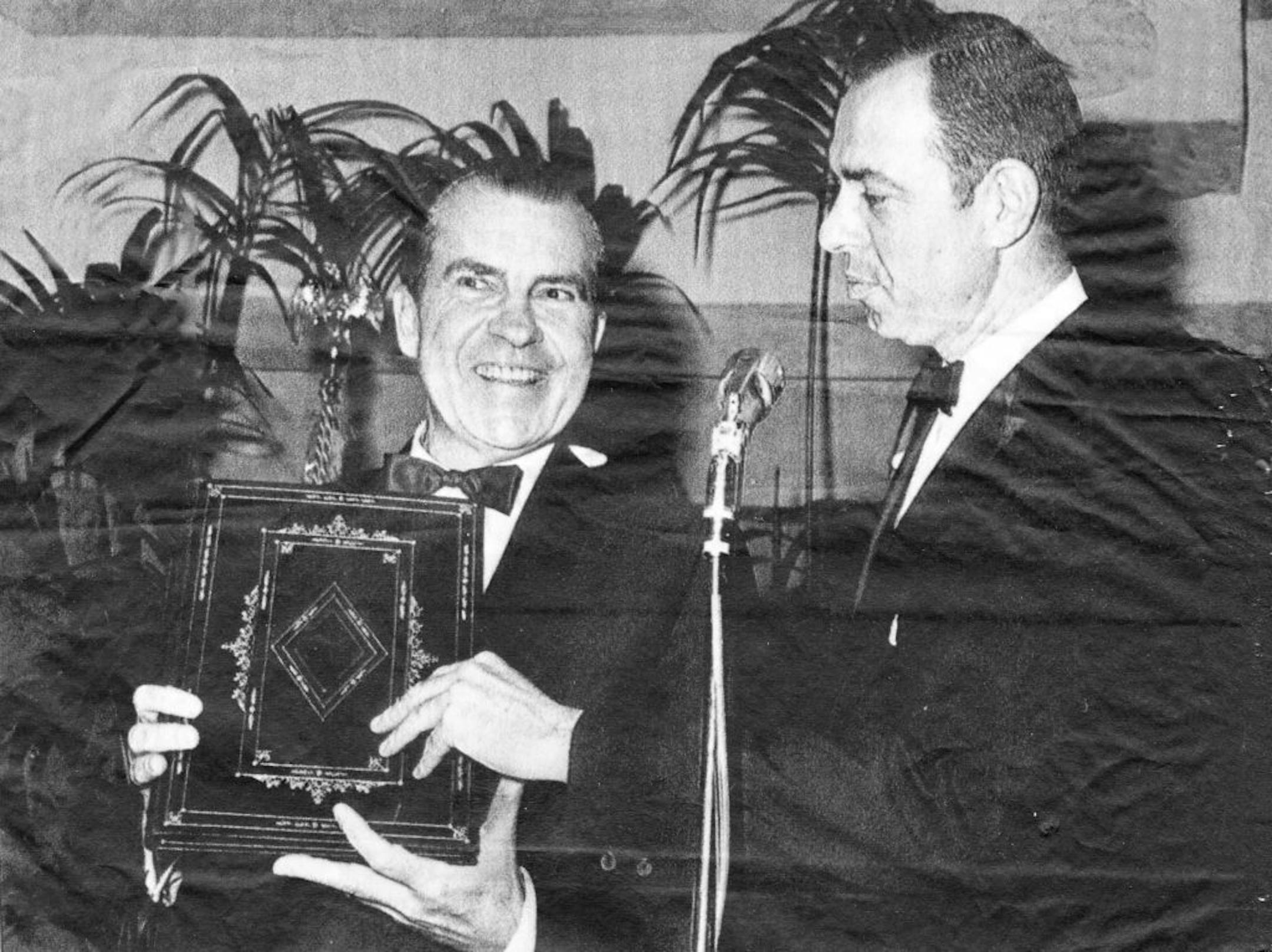 President Nixon received a gold-tooled leather legal-pad at at annual dinner of the White House Correspondents Assoc.. Presented by Charles W. Bailey, chief of The Minneapolis Tribune Washington Bureau.