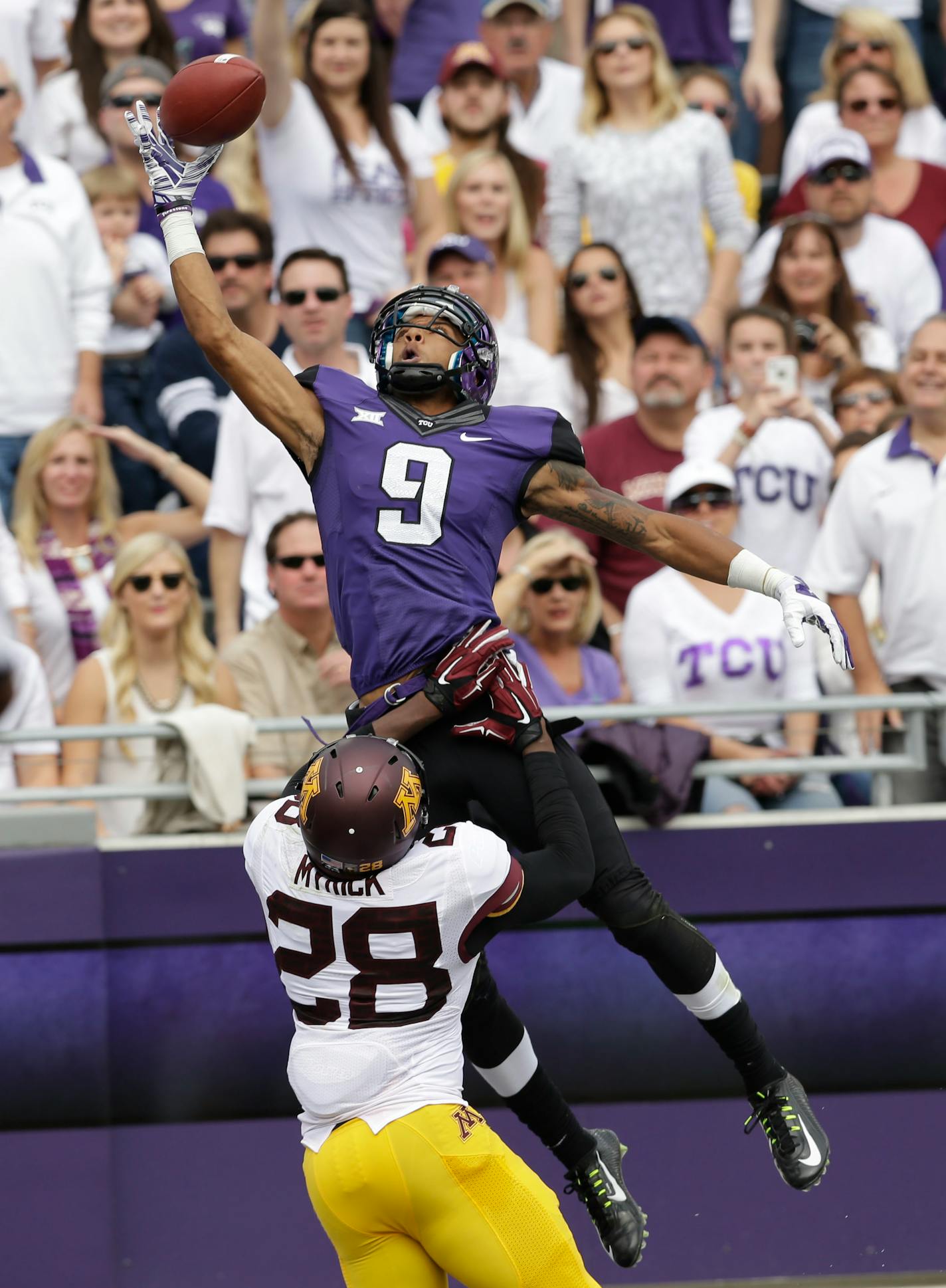 TCU wide receiver Josh Doctson (9) jumps to one-hand catch a touchdown pass over Minnesota defensive back Jalen Myrick (28) during the second quarter of an NCAA college football game, Saturday, Sept. 13, 2014, in Fort Worth, Texas. (AP Photo/LM Otero)