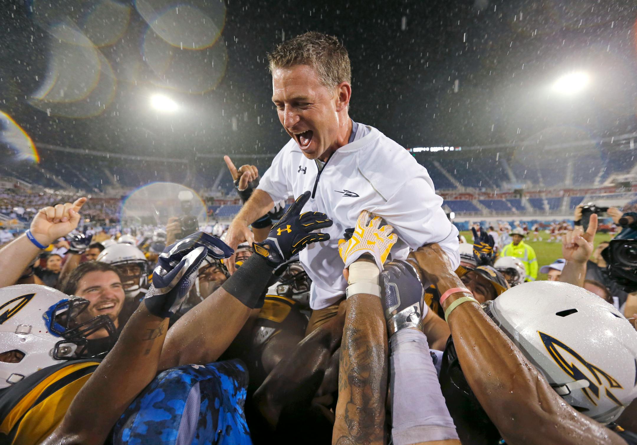 Toledo coach Jason Candle celebrated with his players after they defeated Temple 32-17 in the Boca Raton Bowl on Tuesday night in Boca Raton, Fla.