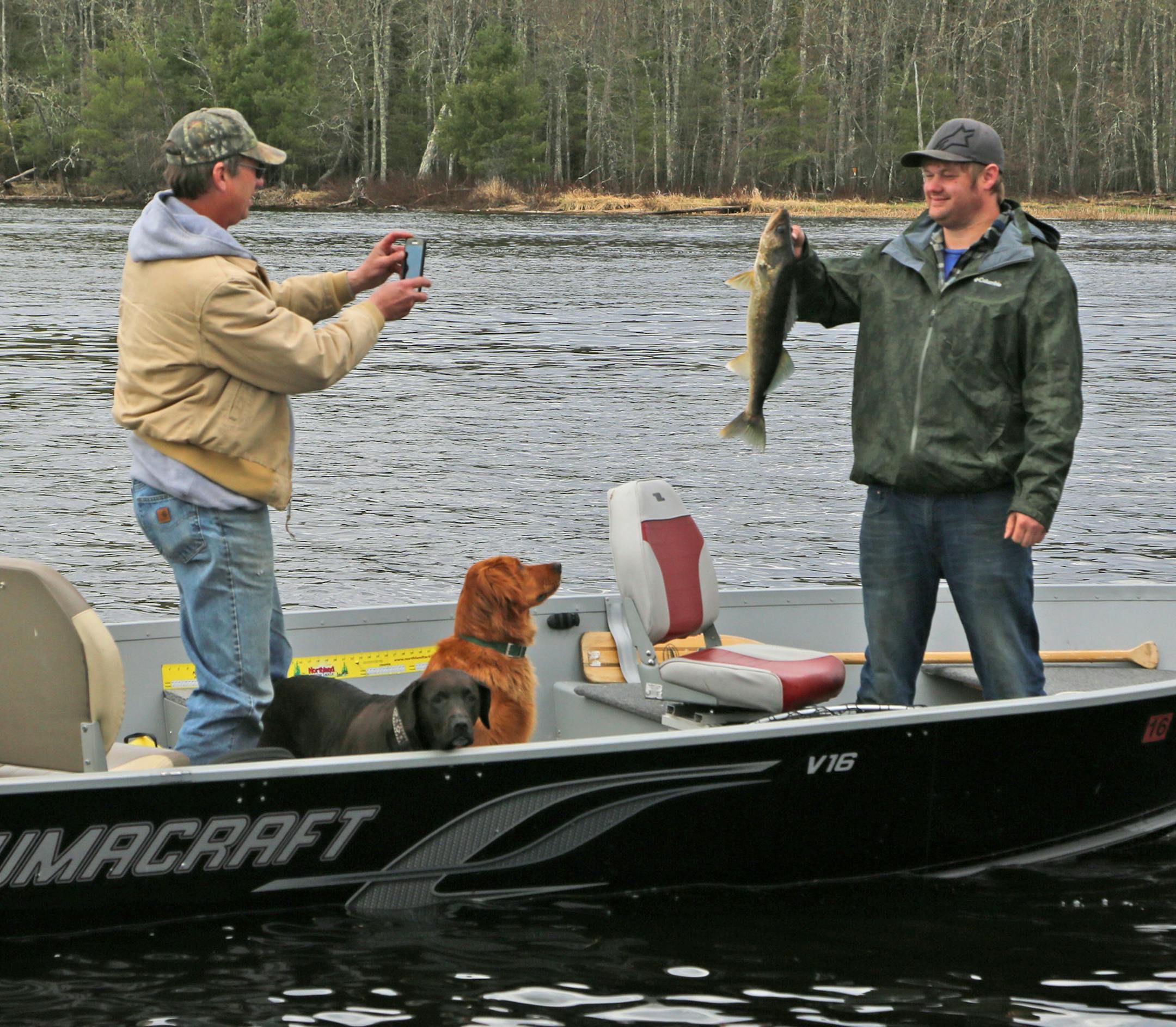 Grant Goette of Duluth posed holding a 24-inch walleye while his dad, David, snapped a photo. Fishing companions Blackie and Remington rounded out the party on Crane Lake Saturday morning. The fish was released. On Crane Lake, walleyes must be under 17 inches to be kept, with one much larger trophy fish also allowed in a limit of four.