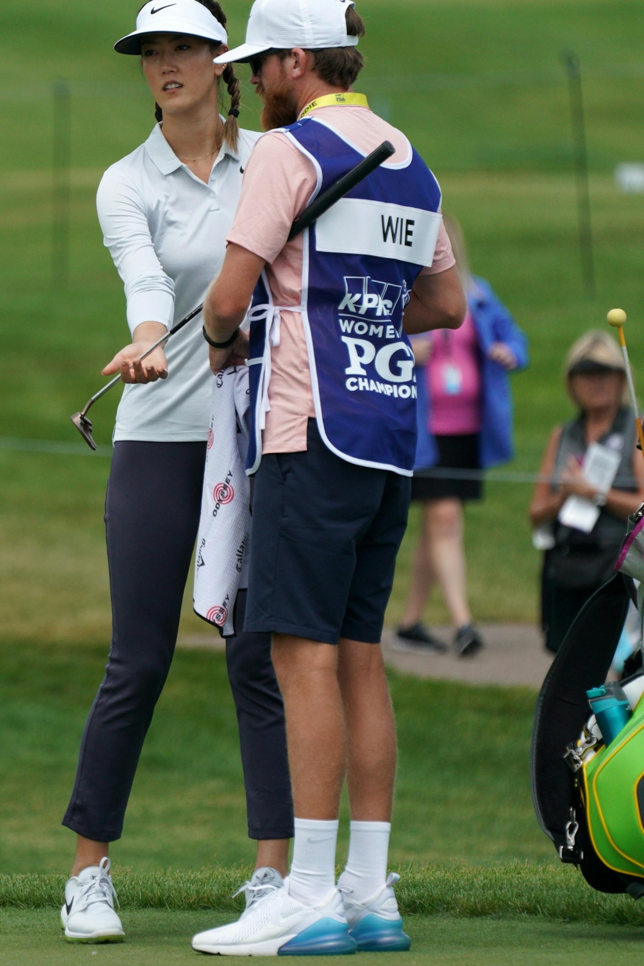 Michelle Wie swapped clubs with her caddie on the 1st hole green Tuesday afternoon.