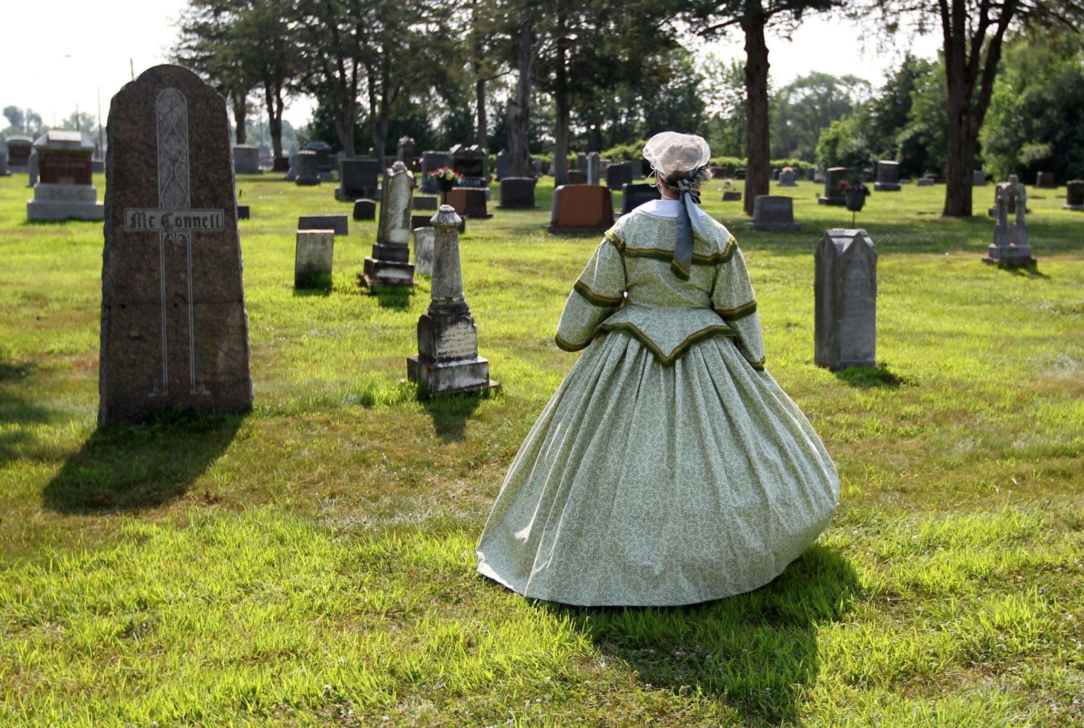 Dressed in period costume, Allison Drtina of the Scott County Historical Society leads a tour of Civil War gravestones at Oakwood Cemetery in Belle Plaine as part of the 150th anniversary of the war July 14, 2012.