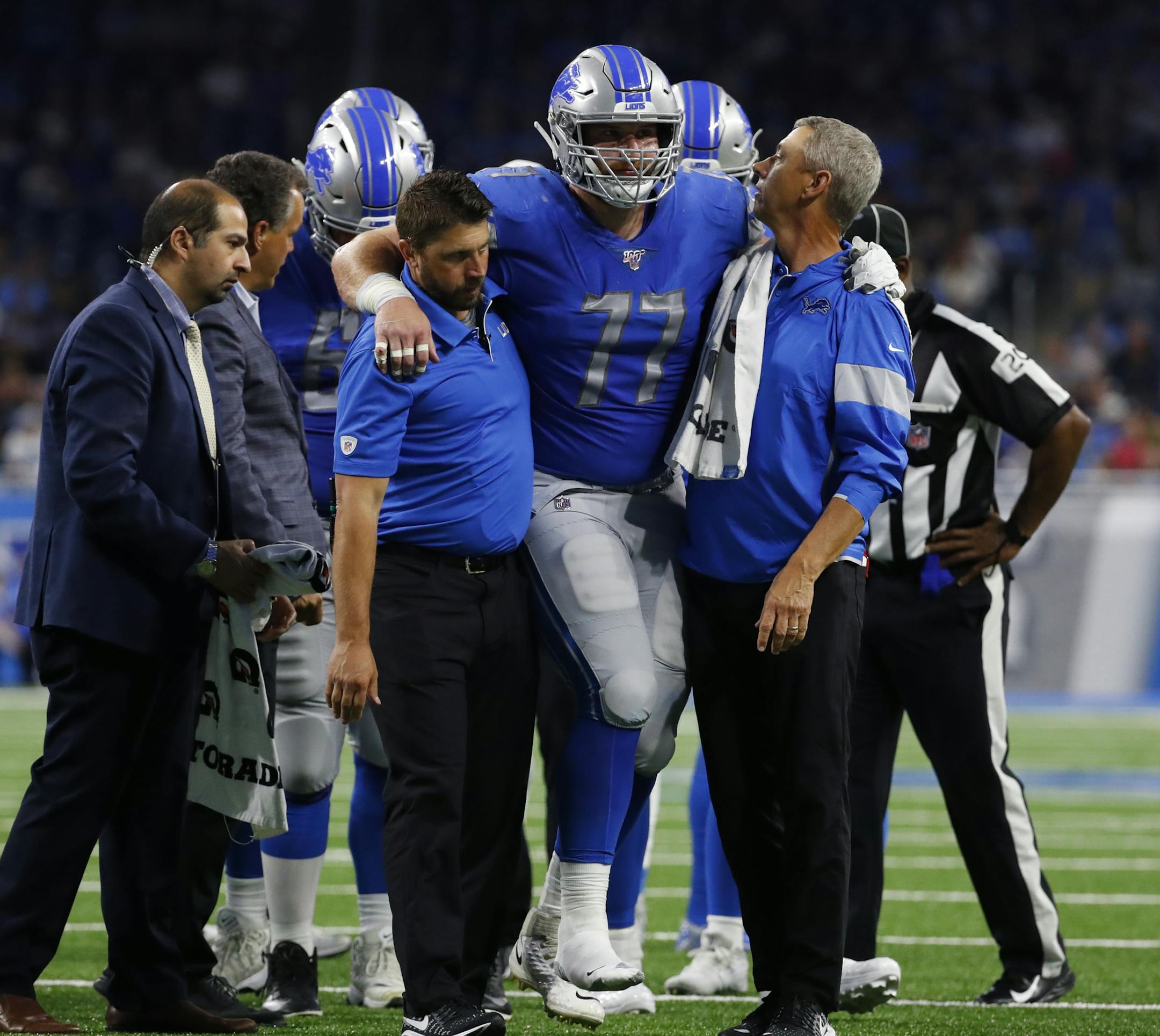 Detroit Lions offensive guard Frank Ragnow (77) is helped off the field by medical staff in the first half of an NFL preseason football game against the Buffalo Bills in Detroit, Friday, Aug. 23, 2019. (AP Photo/Rick Osentoski)