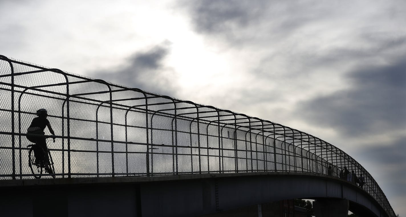 A cyclist was among the few people who gathered on the 24th street pedestrian bridge to get a glimpse and photograph the Minneapolis Skyline Thursday morning June 7, 2018 in Minneapolis, MN. ] A new bridge will be constructed as part of the crosstown project. JERRY HOLT &#xef; jerry.holt@startribune.com