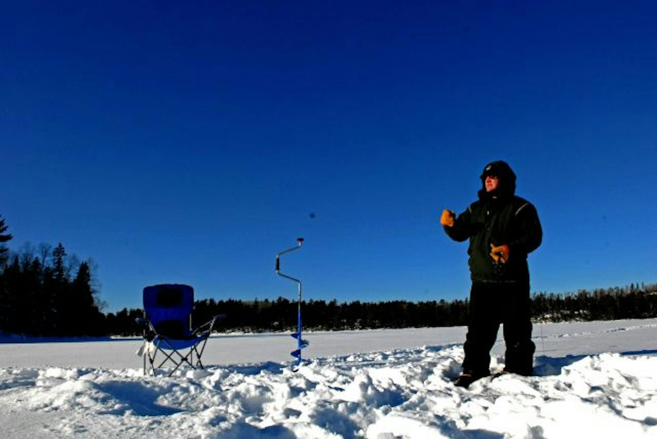 Beneath a peerless blue sky on a day that temperatures dipped to 29 degrees below zero, Stu McEntyre of Ely tried to fool a lake trout to the surface of Knife Lake in the boundary waters.