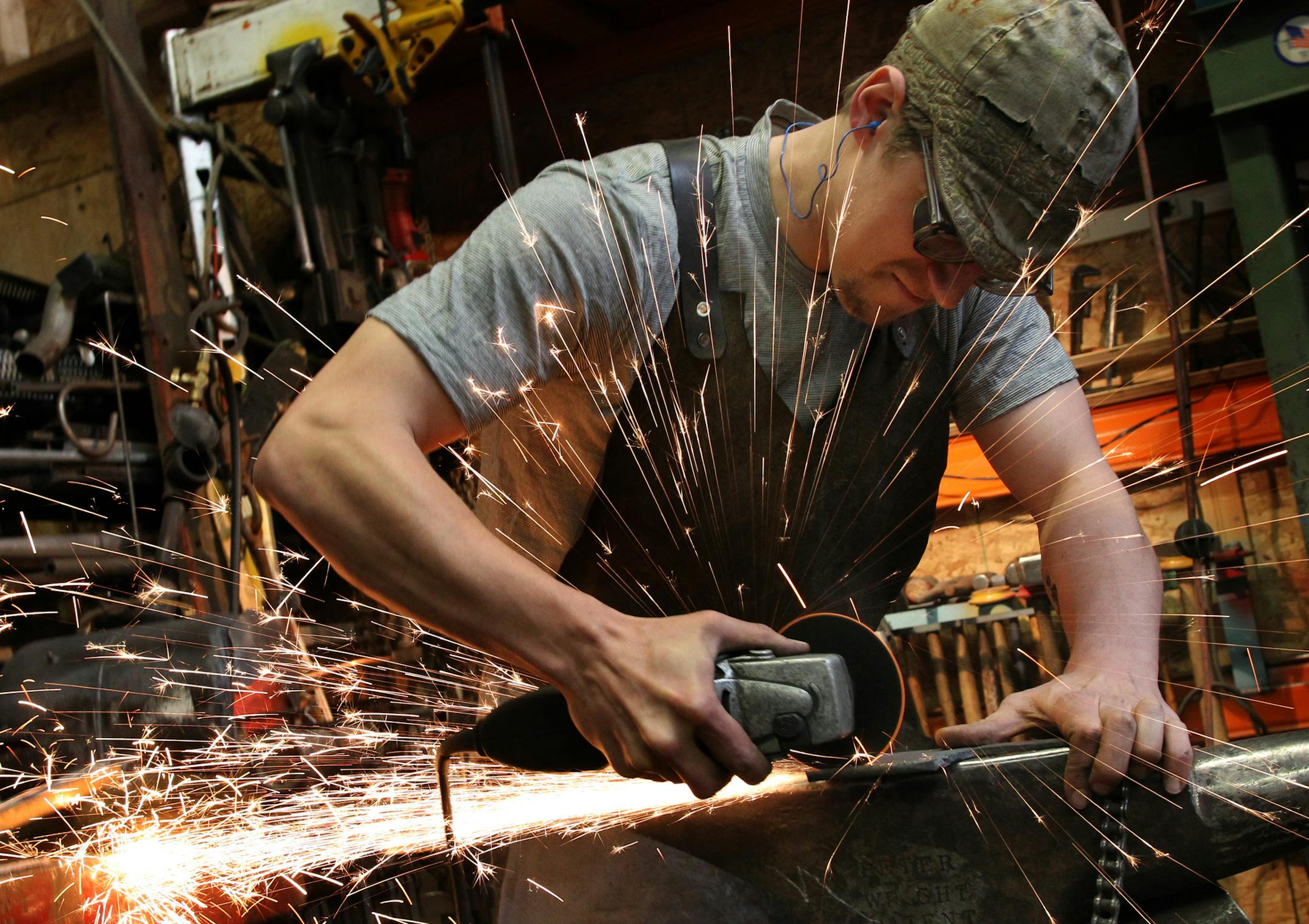 Photo column on How I got this Body: Hans Early-Nelson Primitive Precision works on a knife the old school way in his shop in Minneapolis