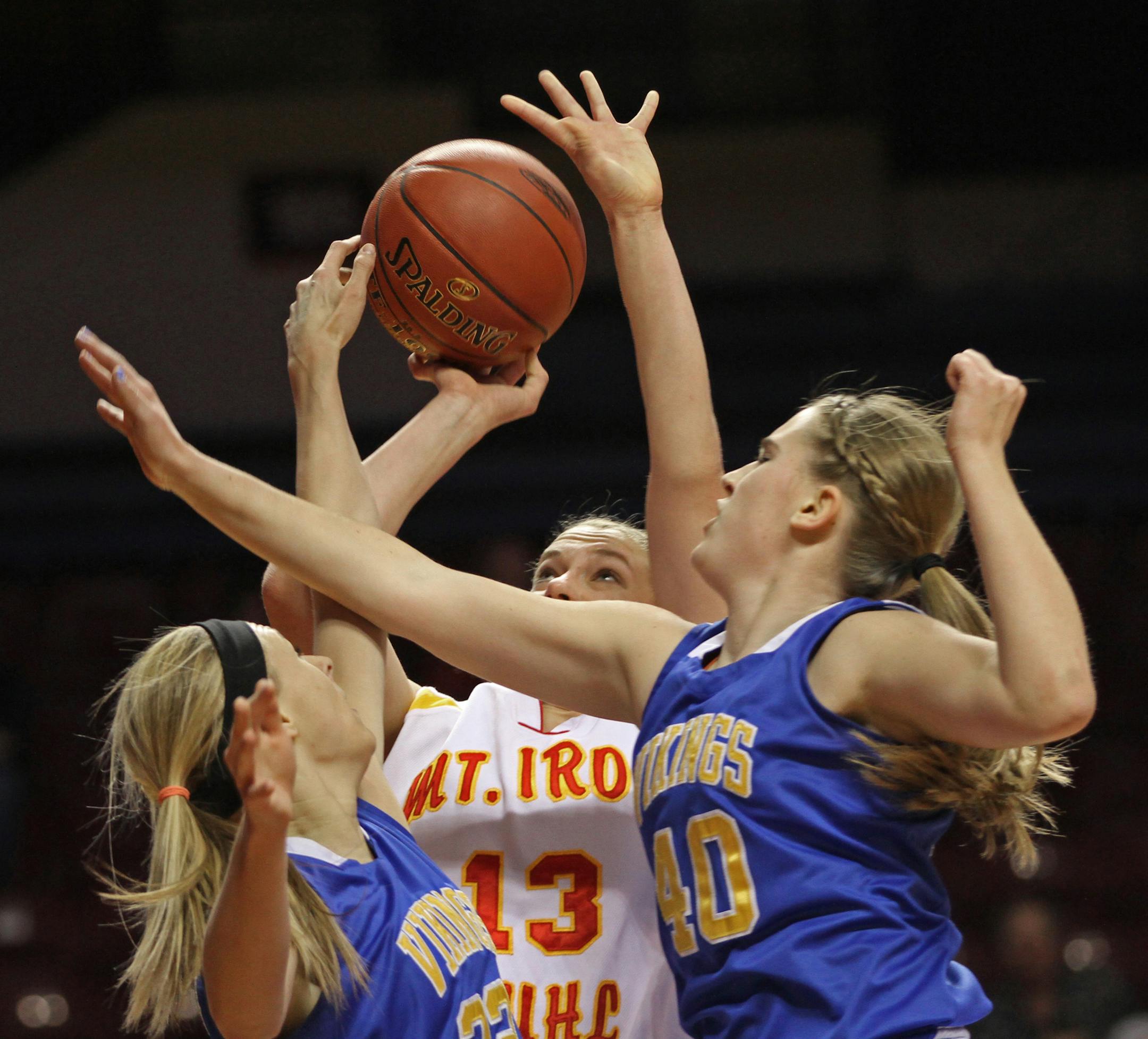 Class 1A girls' basketball state quarterfinals at Williams Arena, 3/14/13, Minneota vs. Mountain Iron-Buhl, (center) Mountain Iron-Buhl's Laura Ostman shot against the Minneota defense.] Bruce Bisping/Star Tribune bbisping@startribune.com Laura Ostman/roster.