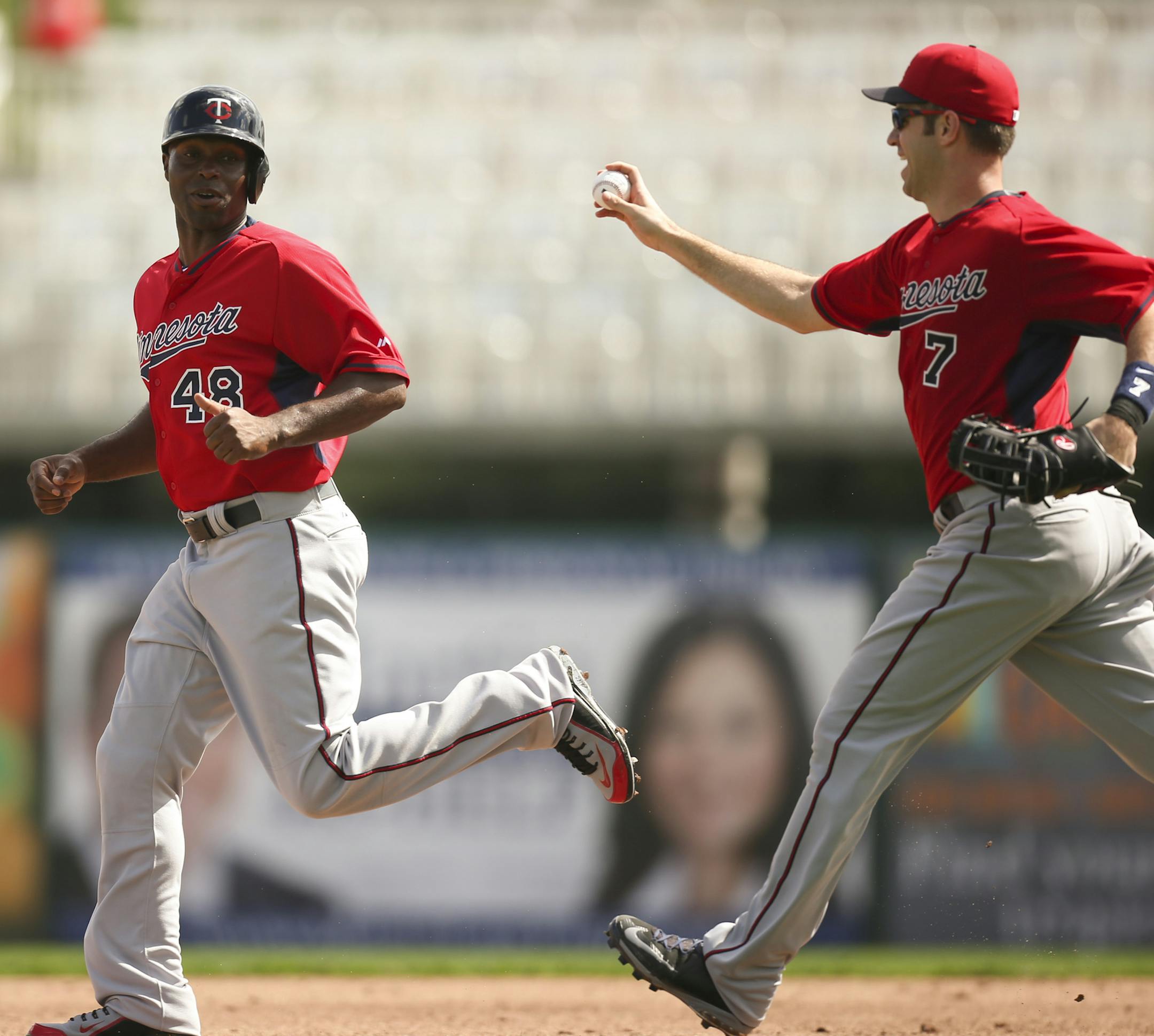 Twins outfielder Torii Hunter tried to elude first baseman Joe Mauer (7) during a drill Monday morning at Hammond Stadium. ] JEFF WHEELER ï jeff.wheeler@startribune.com The entire Twins squad worked out again Monday morning, March 2, 2015, at spring training in Fort Myers, FL.