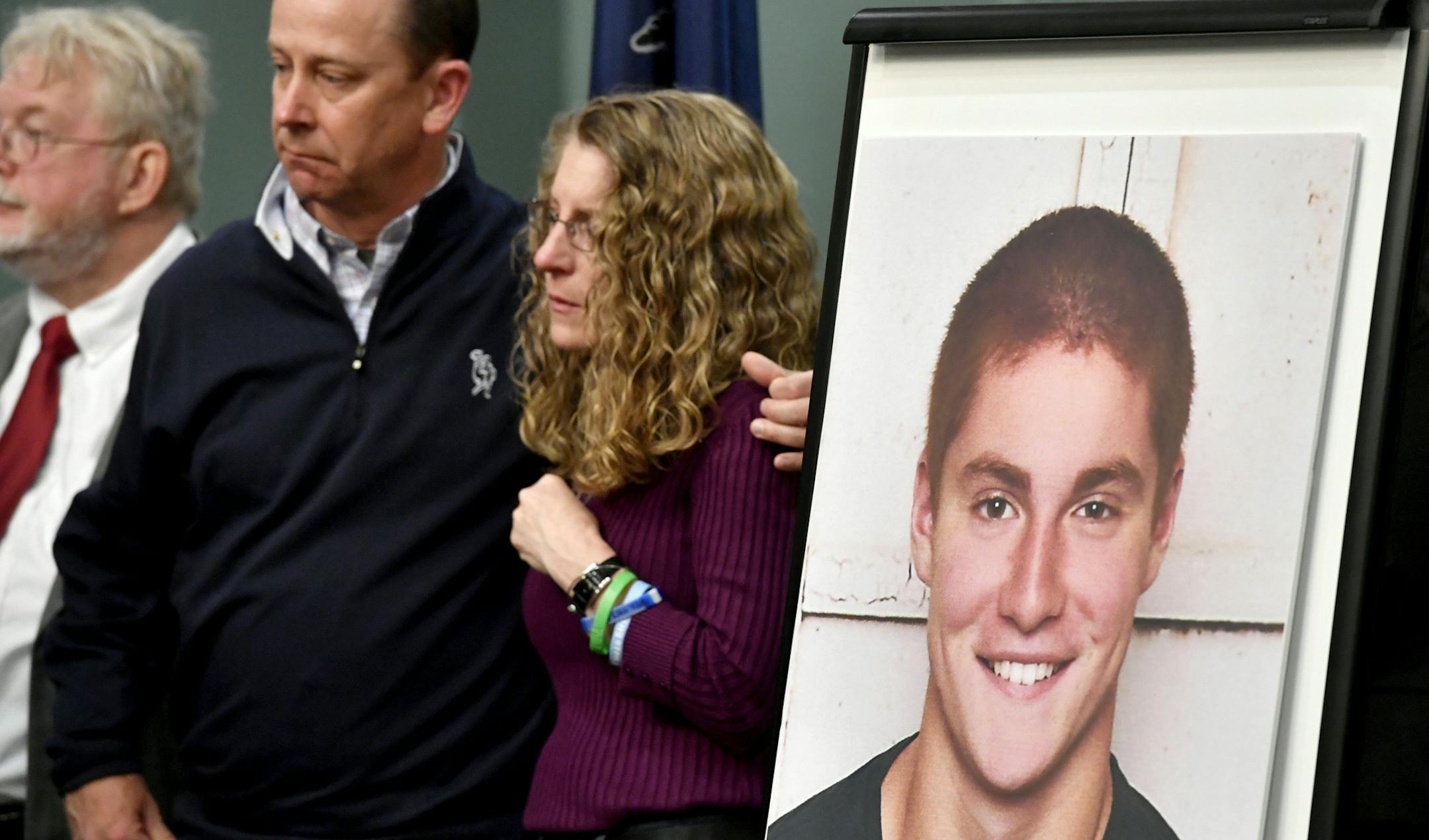 FILE – In this May 5, 2017, file photo, Jim and Evelyn Piazza, center, stand by as Centre County, Pa., prosecutors discuss an investigation into the death of their son Timothy Piazza, seen in photo at right, during a news conference in Bellefonte, Pa. A preliminary hearing is set to resume Monday, July 10, for 18 Penn State fraternity members who are facing charges in connection with the death of Timothy Piazza. (Abby Drey /Centre Daily Times via AP, File)