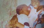 George Floyd as a baby, in the arms of his mother, Larcenia Floyd.