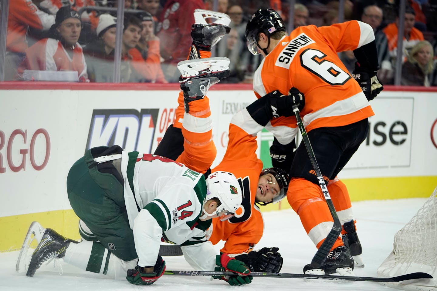 Philadelphia Flyers' Scott Laughton, center, collides with Travis Sanheim, right, and Minnesota Wild's Joel Eriksson Ek during the first period of an NHL hockey game, Saturday, Nov. 11, 2017, in Philadelphia. (AP Photo/Matt Slocum)