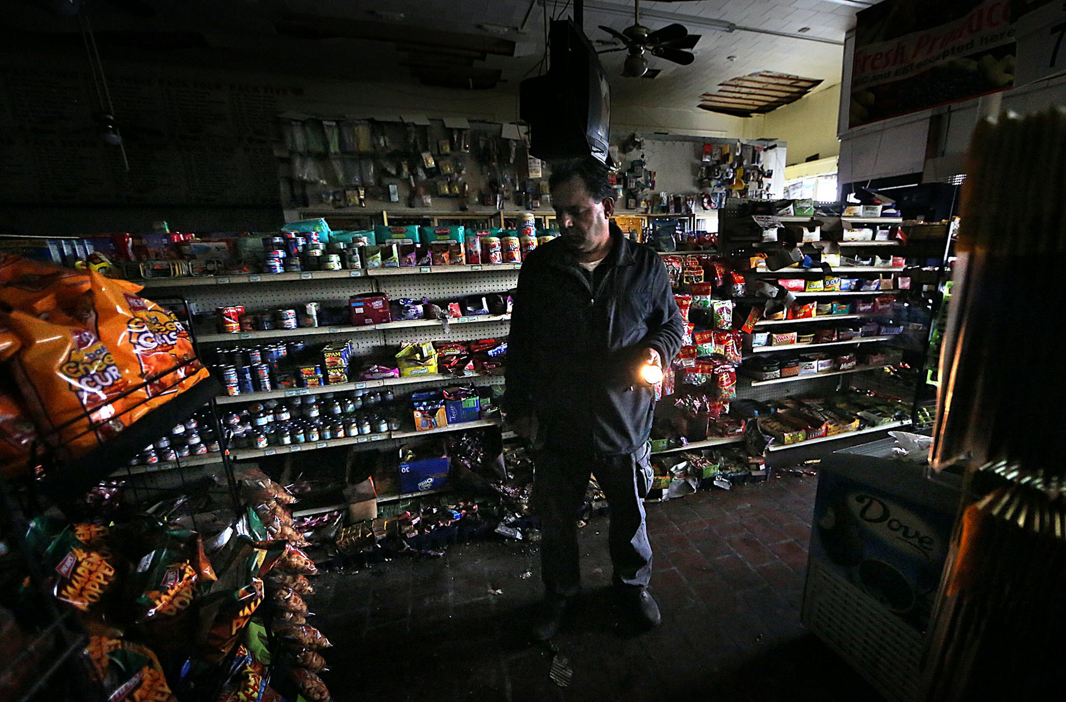 Nader Abuammo looked over the heavy damage caused to his store, Brix Grocery, in the 900 block of West Broadway. Apartments on the upper floors of the building were destroyed. ] JIM GEHRZ ï james.gehrz@startribune.com / Minneapolis, MN / April 24, 2015 /12:00 PM - BACKGROUND INFORMATION: The future of a historic north Minneapolis commercial strip is uncertain more than a week after a blaze ripped through its brick walls. The city said Thursday it won't demolish the properties, leaving build
