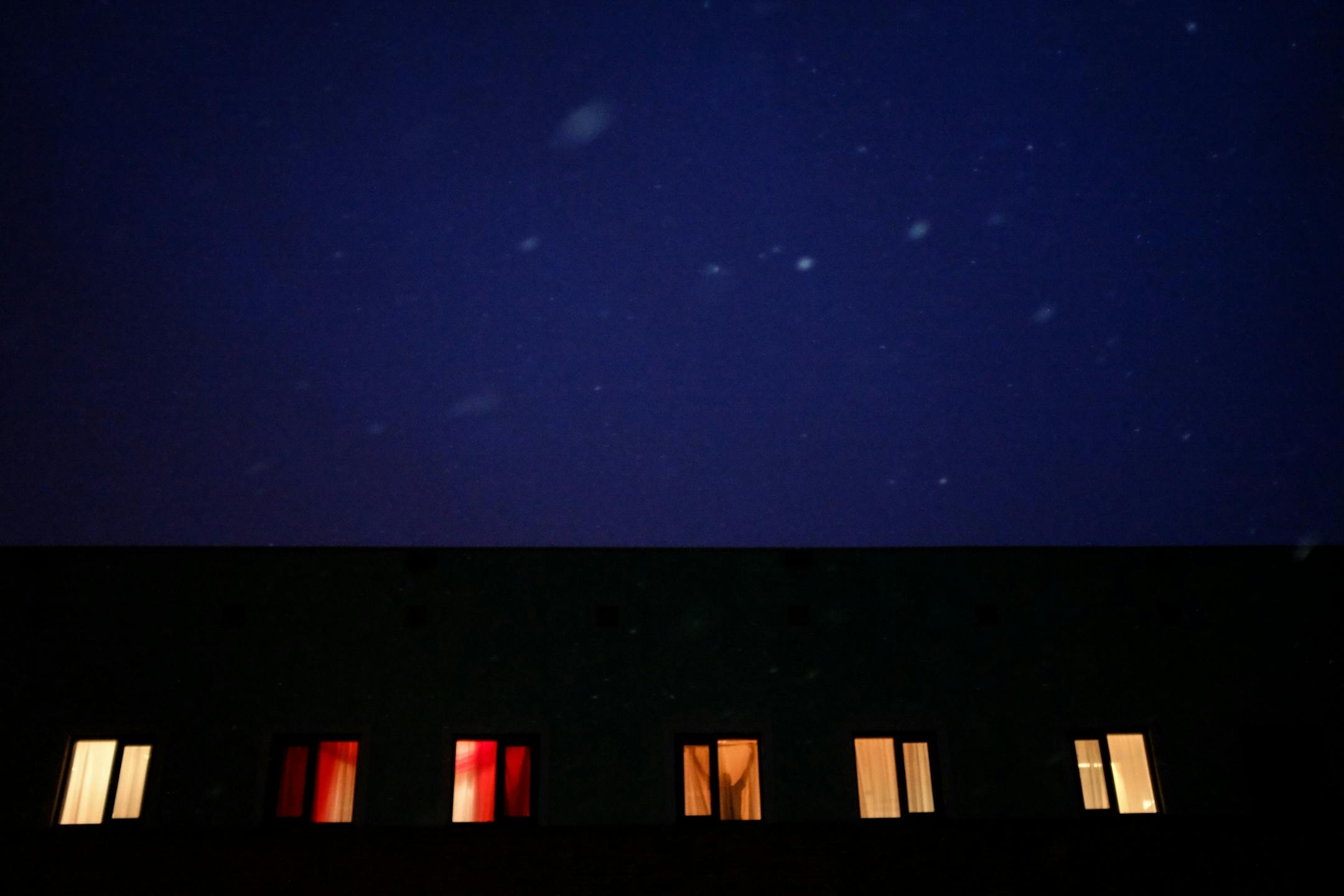 A man hung curtains in a building on East Lake Street Friday night in Minneapolis.