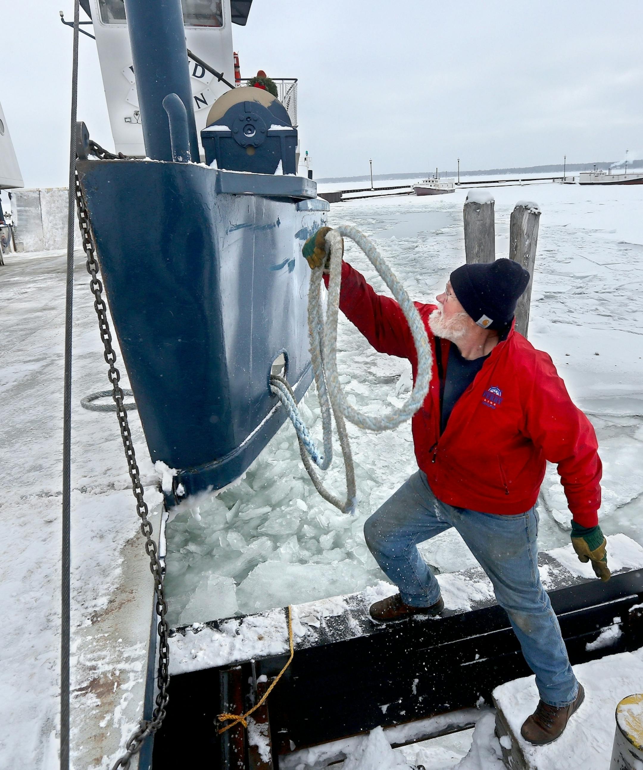 t1.5.18 Bob King -- 010618.N.DNT.FERRYc5 -- Captain Matthew Olson of Ashland unties the Island Queen ferry before departing from Bayfield to Madeline Island Friday morning. Bob King / rking@duluthnews.com