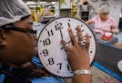 Yolanda Johnson, 45, examines parts of clocks by touching them as she works on the assembly line on Oct. 6, 2017 in Chicago. Workers are manufacturing