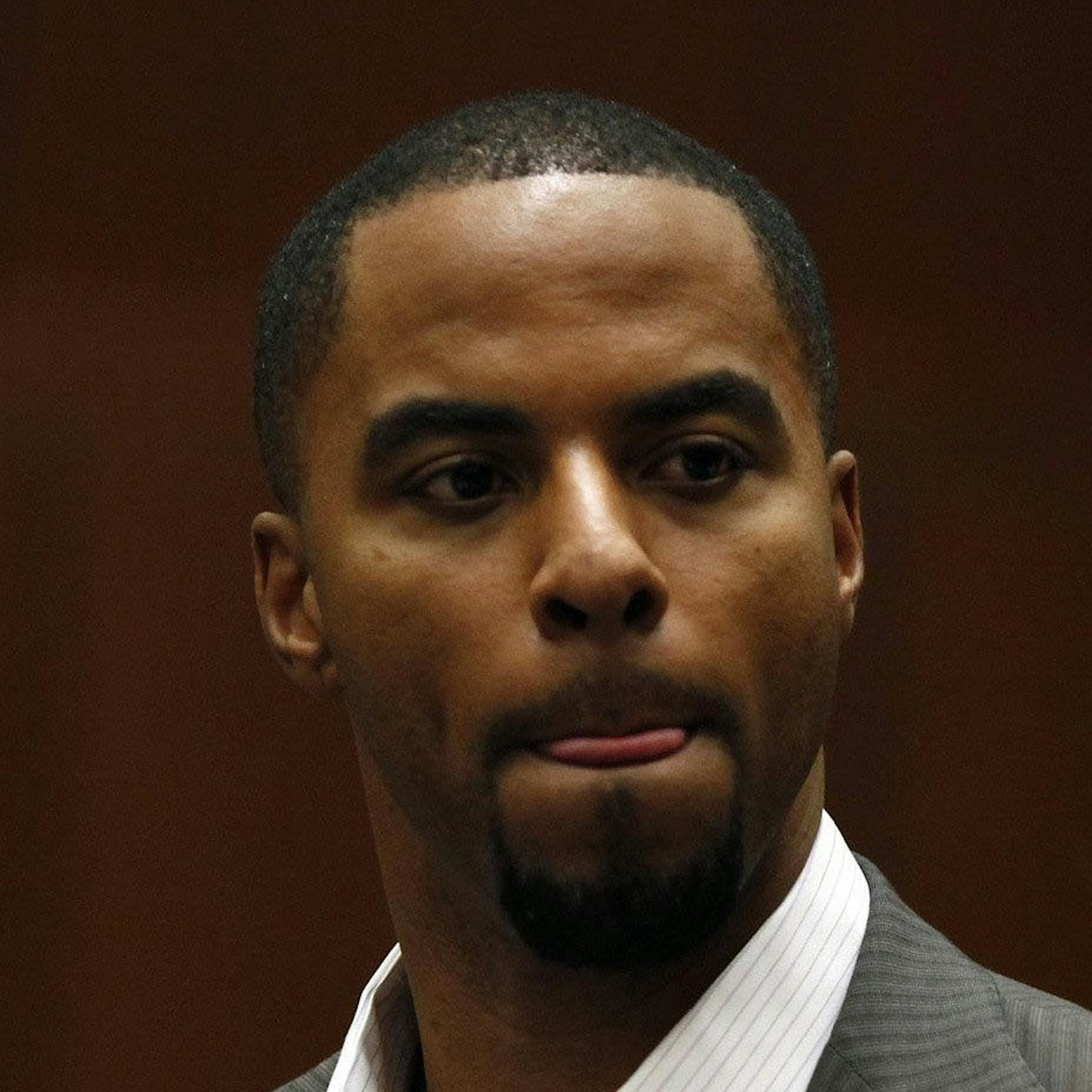 Former pro football player Darren Sharper appears in court with his attorney, Blair Berk, right, and at left attorney Leonard Levine, Friday, Feb. 14, 2014, in Los Angeles. Sharper was charged with drugging and raping two women, one in October and the other last month, the Los Angeles County District Attorney's Office announced. (Liz O. Baylen/Los Angeles Times/MCT) ORG XMIT: 1149209