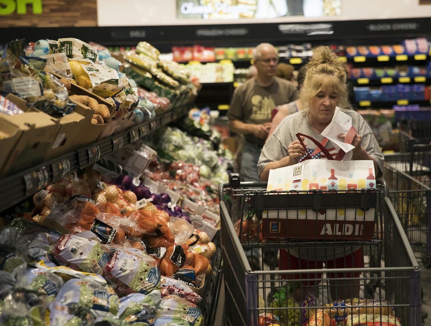 Linda Fox, of Roseville, one of the first to line up and enter the new Aldi store in Roseville, Minn., shopped in the produce section on Thursday, June 8, 2017.