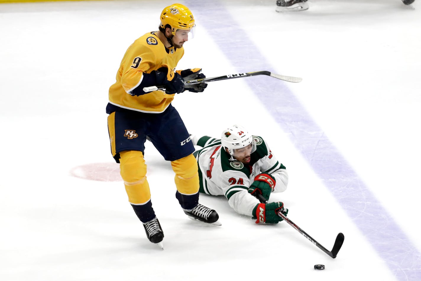 Wild defenseman Matt Dumba reaches for the puck in front of Nashville left wing Filip Forsberg during the third period