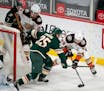 Wild defenseman Jonas Brodin (25) shadowed Ducks left winger Max Jones (49) as he tried to center the puck from behind the Wild net Monday.