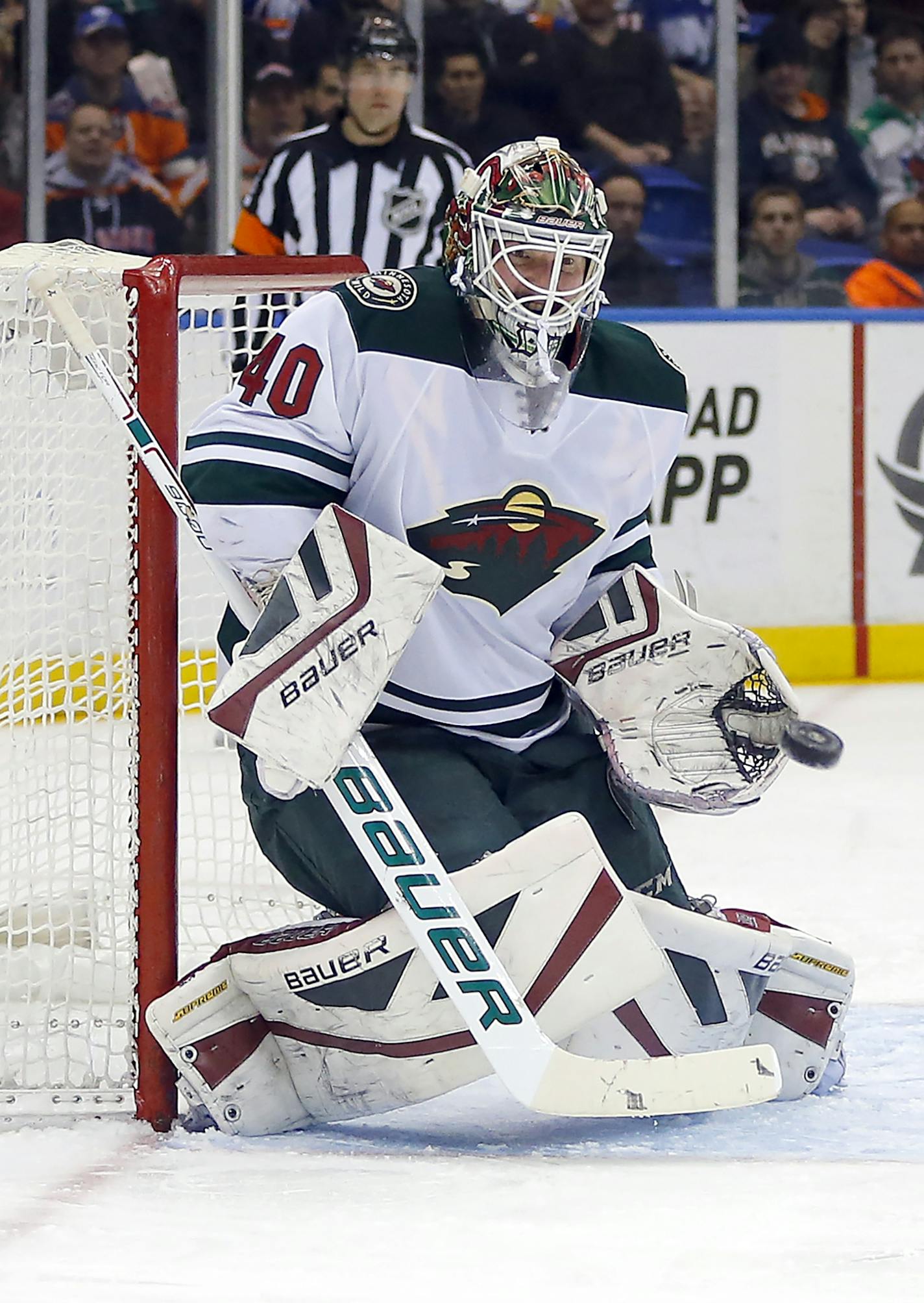 Minnesota Wild goalie Devan Dubnyk makes a save in the second period of an NHL hockey game against the New York Islanders on Tuesday, March 24, 2015, in Uniondale, N.Y. Minnesota won 2-1 in a shootout. (AP Photo/Paul Bereswill) ORG XMIT: MIN2015032421221596