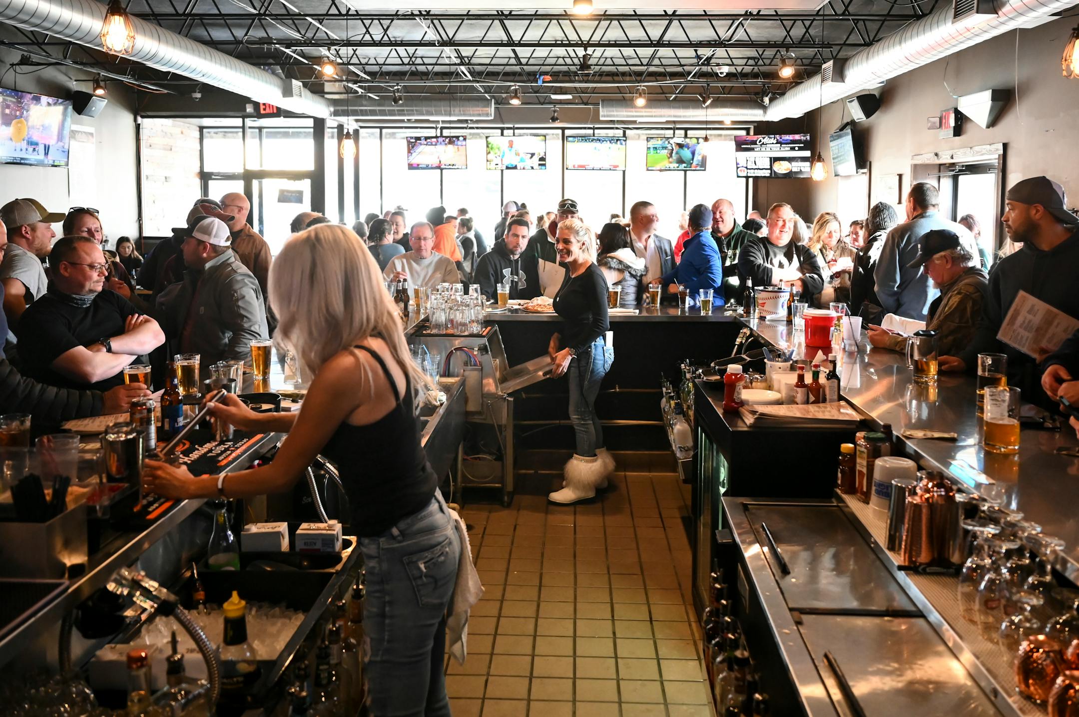 Standing-room only at the bar at Alibi Drinkery in Lakeville, which reopened Wednesday morning in defiance of Gov. Walz.