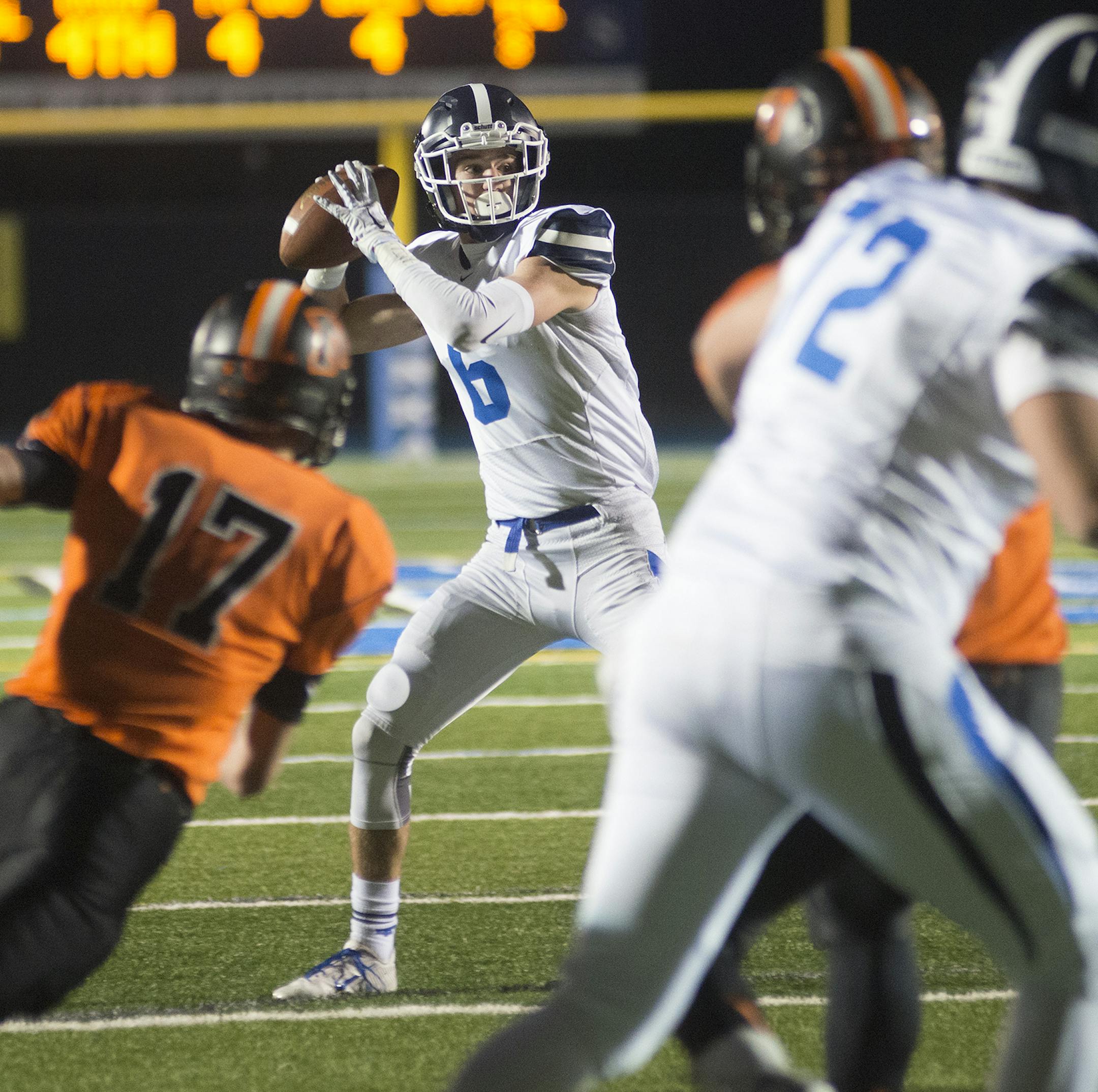 St. Thomas Academy's Mac Brown receives some pressure from Moorhead's Jayce Johnson as he attempts to complete a pass on a fake field goal play during the second quarter of Friday night's Boy's Class 5A Semifinal game at Minnetona High School. ] (Matthew Hintz, 110715, Minnetonka)