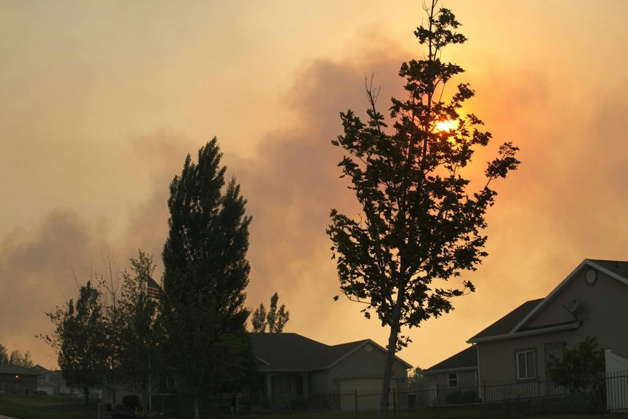 Smoke filled the sky above Saratoga Springs, Utah, last June, where homes have been evacuated because of a raging wildfire.