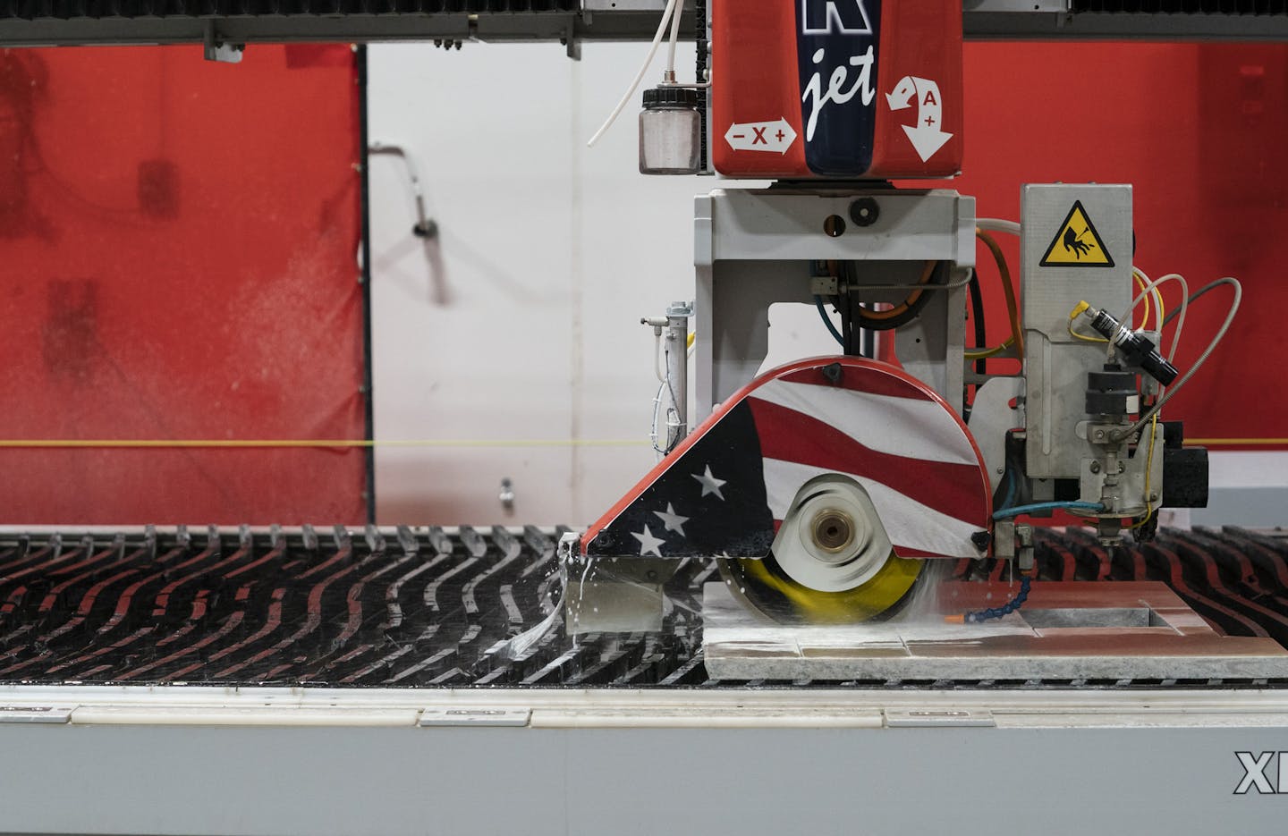 Park Industries in St. Cloud, which makes machines that cut granite, has revamped its recruitment process to attract needed workers. Shown is one of the sample machines cutting granite in September. (RENEE JONES SCHNEIDER/Star Tribune)