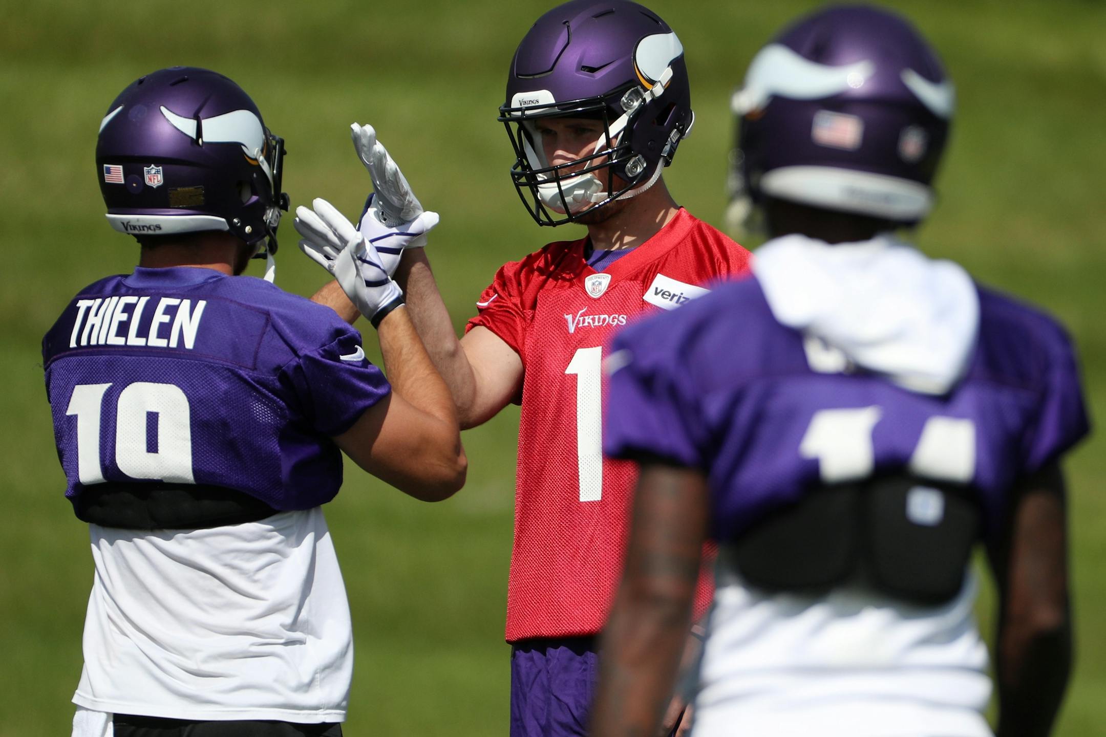 Minnesota Vikings quarterback Kyle Sloter (1) got a high five from Minnesota Vikings wide receiver Adam Thielen (19) as he practiced with the team last week.