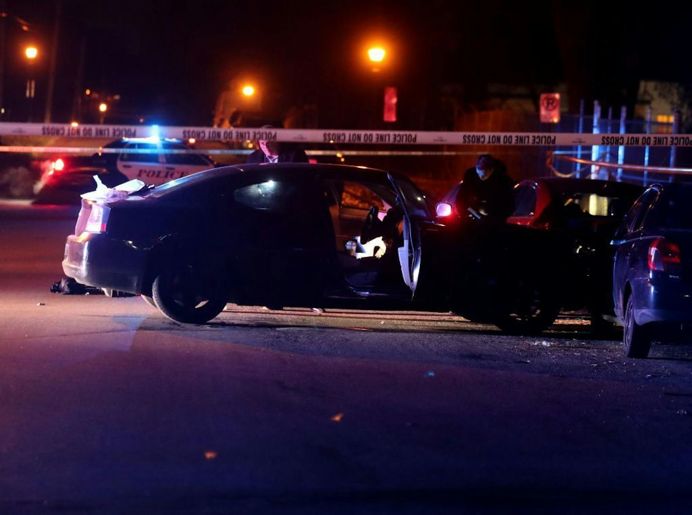 Police investigators on the scene of a multiple shooting with at least one dead Saturday night near the intersection of Maryland Ave. E and Hazelwood St. in St. Paul, MN.