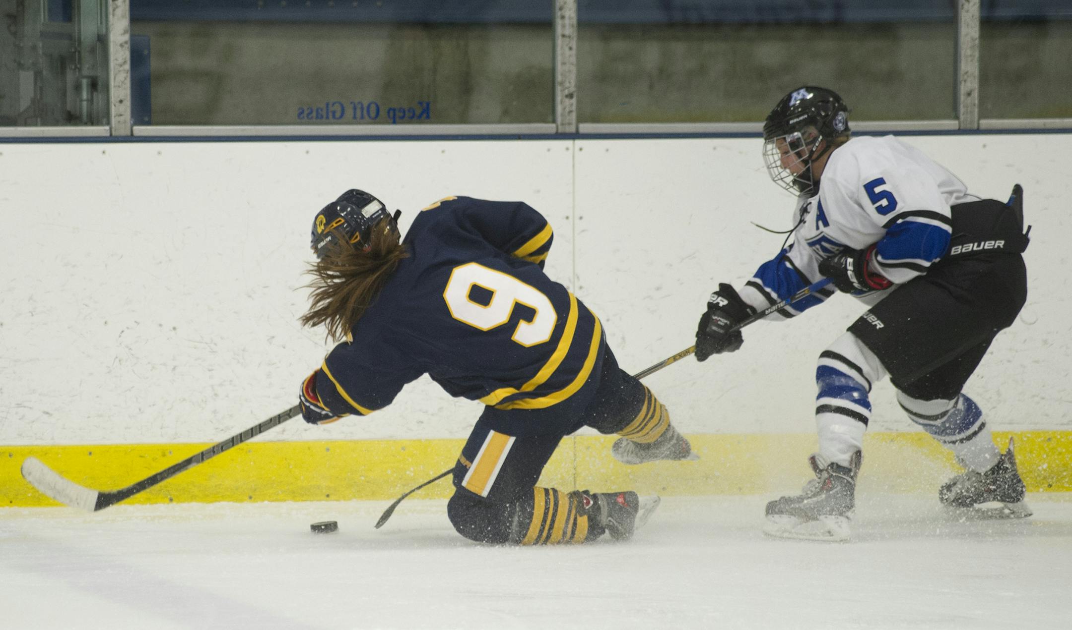 Minnetonka's Presley Norby steals the puck away from Wayzata's Maddy Johnson during the third period of Friday night's game at the Parade Ice Garden in Minneapolis, MN. Minnetonka went on to win 3-2 in overtime. ] (Matthew Hintz, 021314, Minneapolis)