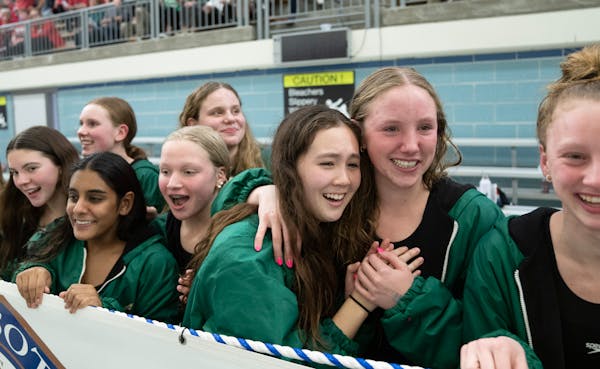 Edina swimmers embraced as they watched the final event Saturday knowing they would be state champions.