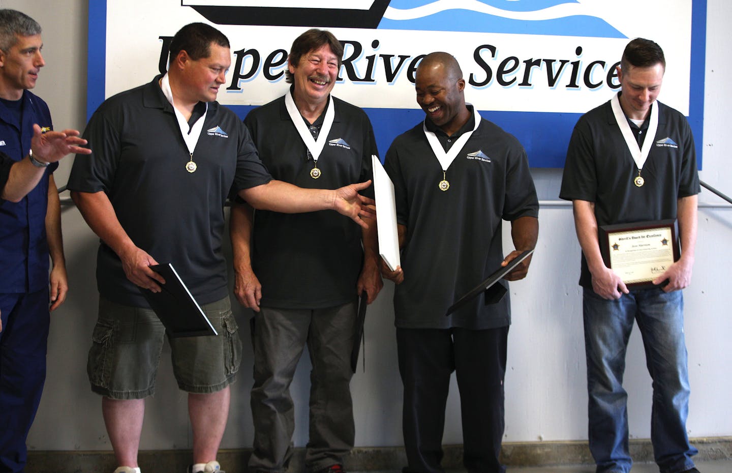 (From left) Russ Galvan, Randy Kohl and Beasley Baker shared a laugh as Jesse Harrison stood to the side softly smiling. ] ALEX KORMANN &#x2022; alex.kormann@startribune.com On May 2, 2018, Beasley Baker, an Upper River Services employee, spotted a man jump from the Robert Street Bridge in an attempted suicide. Baker watched the man continue to float down the Mississippi River. He, along with four other workers then commandeered a tug boat to attempt a rescue. Relying on their training for emerg