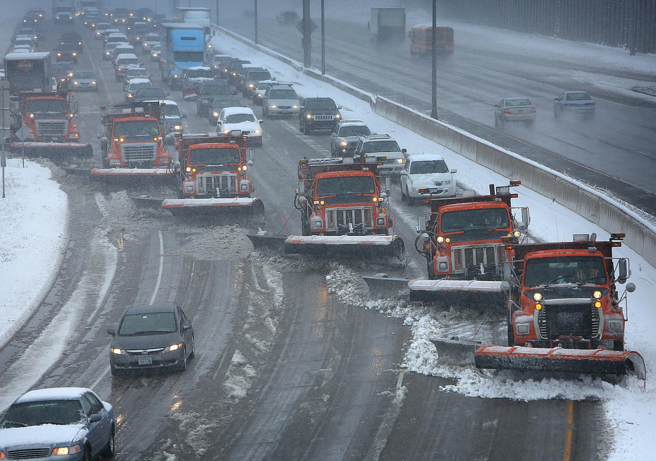 Snow plows teamed up to clear snow from I-94 near in St. Paul on April 11, 2013.