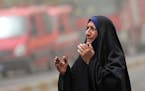 An Iraqi woman grieves at the scene of a deadly suicide a car bomb at a commercial area in Karada neighborhood, Baghdad, Iraq, Sunday, July 3, 2016. D