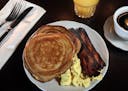 Sourdough pancakes with two eggs and house bacon get the day off to a good start at Mona Restaurant & Bar.
