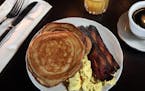 Sourdough pancakes with two eggs and house bacon get the day off to a good start at Mona Restaurant & Bar.