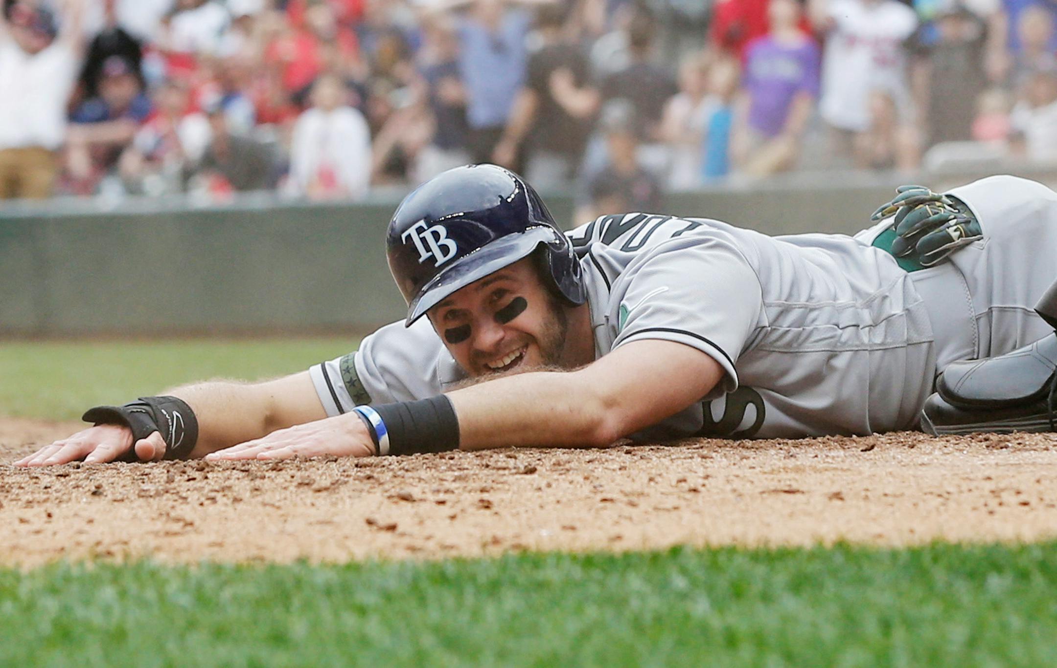 Tampa Bay Rays' Evan Longoria enjoys a laugh as he scores to tie the baseball game on a single by Steven Souza, Jr. in the ninth inning of a baseball game Sunday, May 28, 2017 in Minneapolis. (AP Photo/Jim Mone)