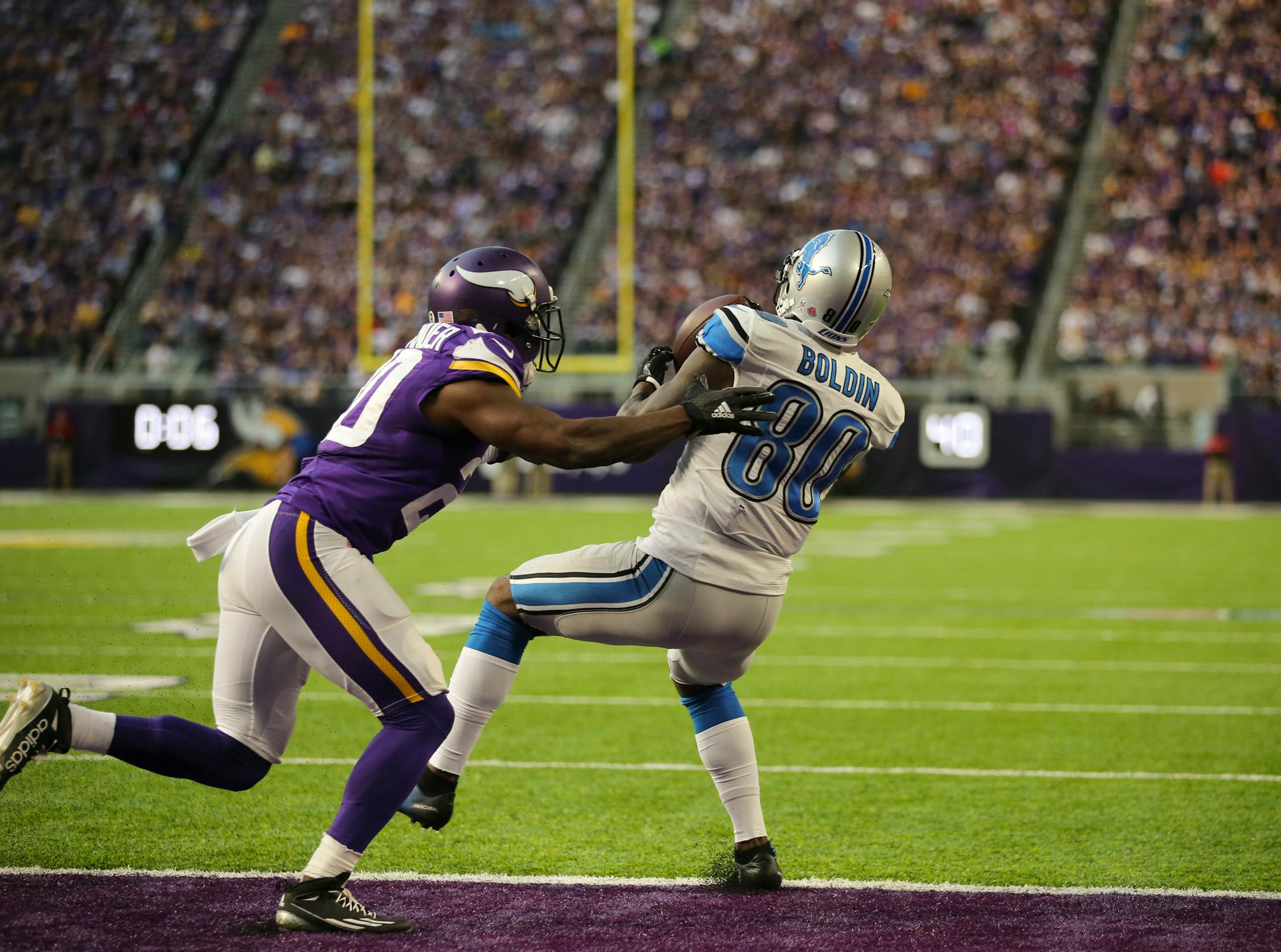 Detroit Lions wide receiver Anquan Boldin (80) scored with a one yard pass reception while covered by Vikings cornerback Mackensie Alexander (20) near the end of the second quarter.