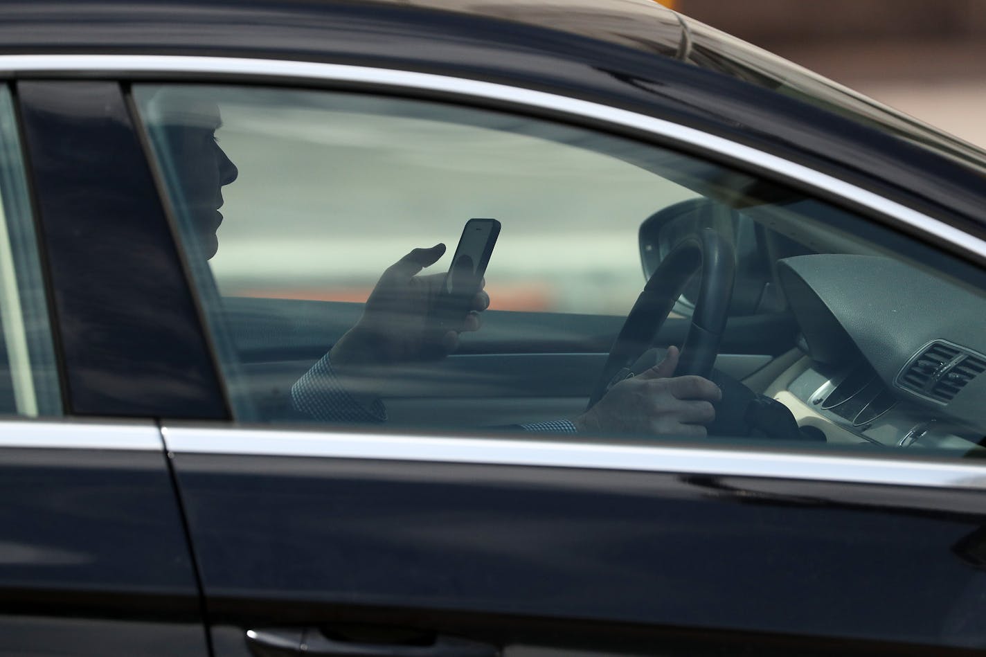 A man used a cell phone while driving in downtown Minneapolis.