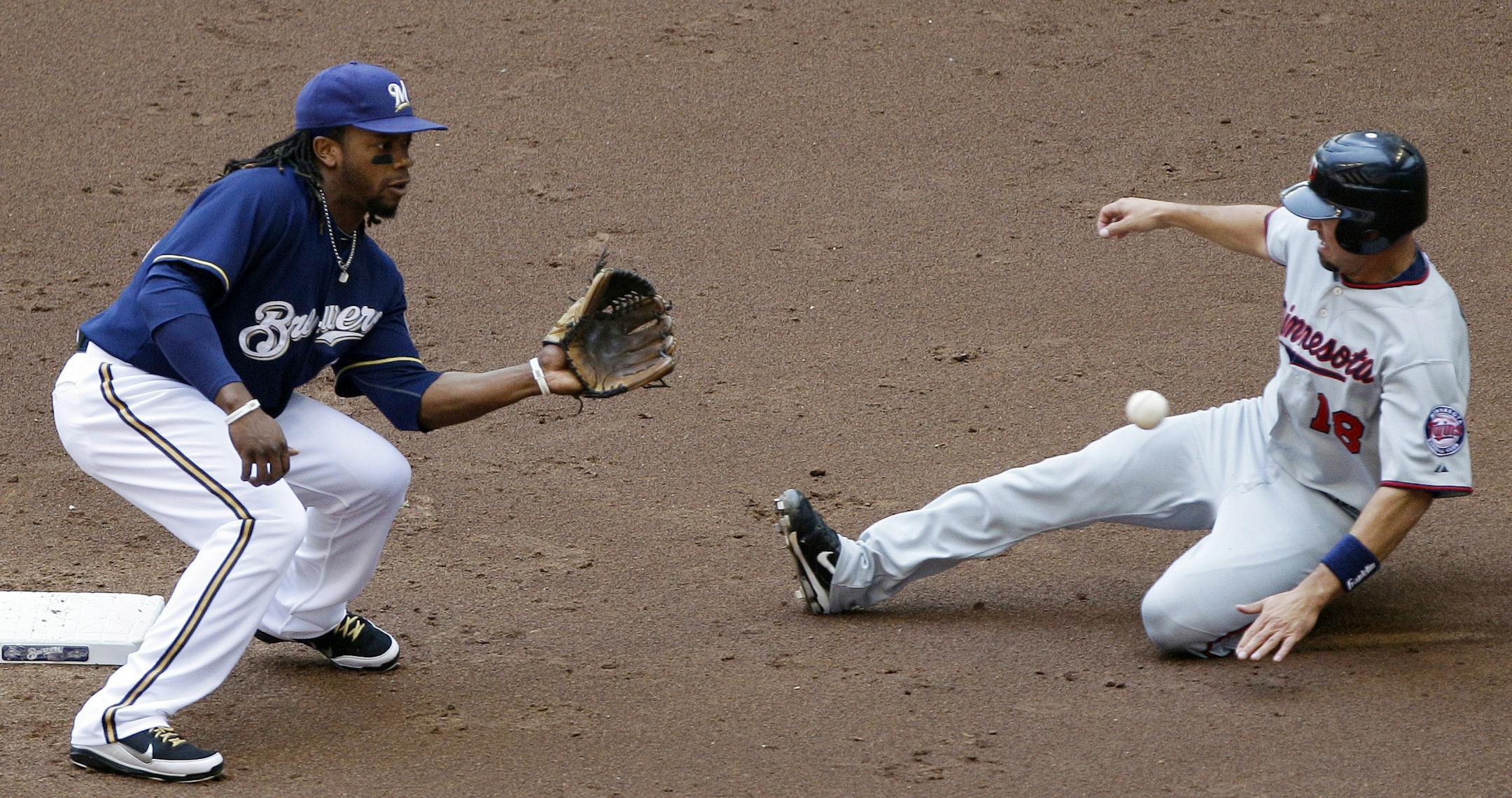 Minnesota Twins' Jason Repko (18) steals second base with Milwaukee Brewers second baseman Rickie Weeks covering during the second inning of an interleague baseball game on Sunday, June 26, 2011, in Milwaukee.