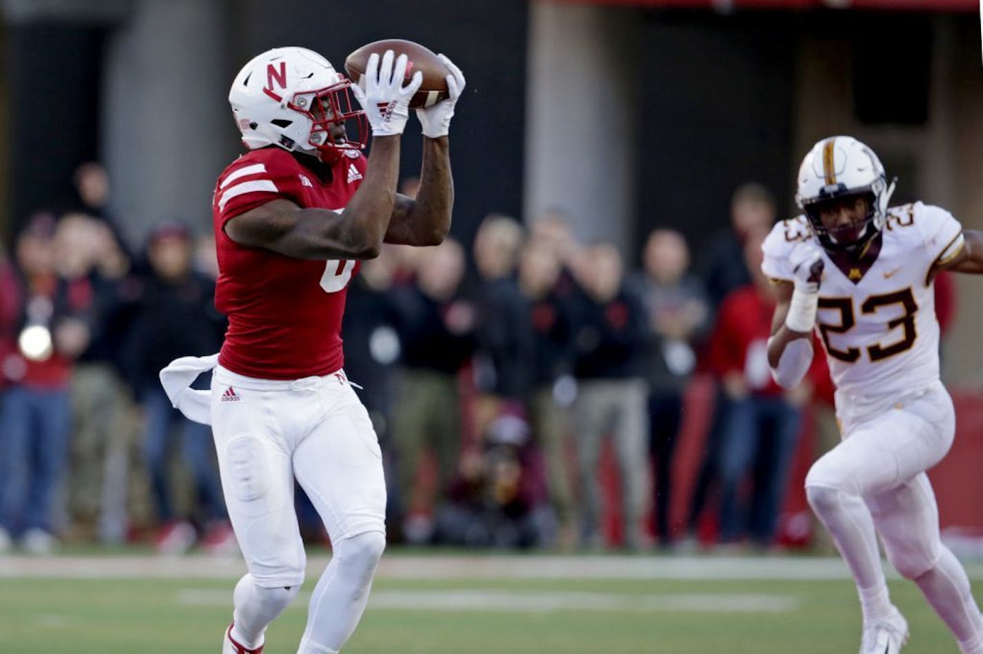 Nebraska wide receiver Stanley Morgan Jr. (8) makes a catch and runs for a touchdown in front of Minnesota defensive back Jordan Howden (23) during the second half of an NCAA college football game in Lincoln, Neb., Saturday, Oct. 20, 2018.