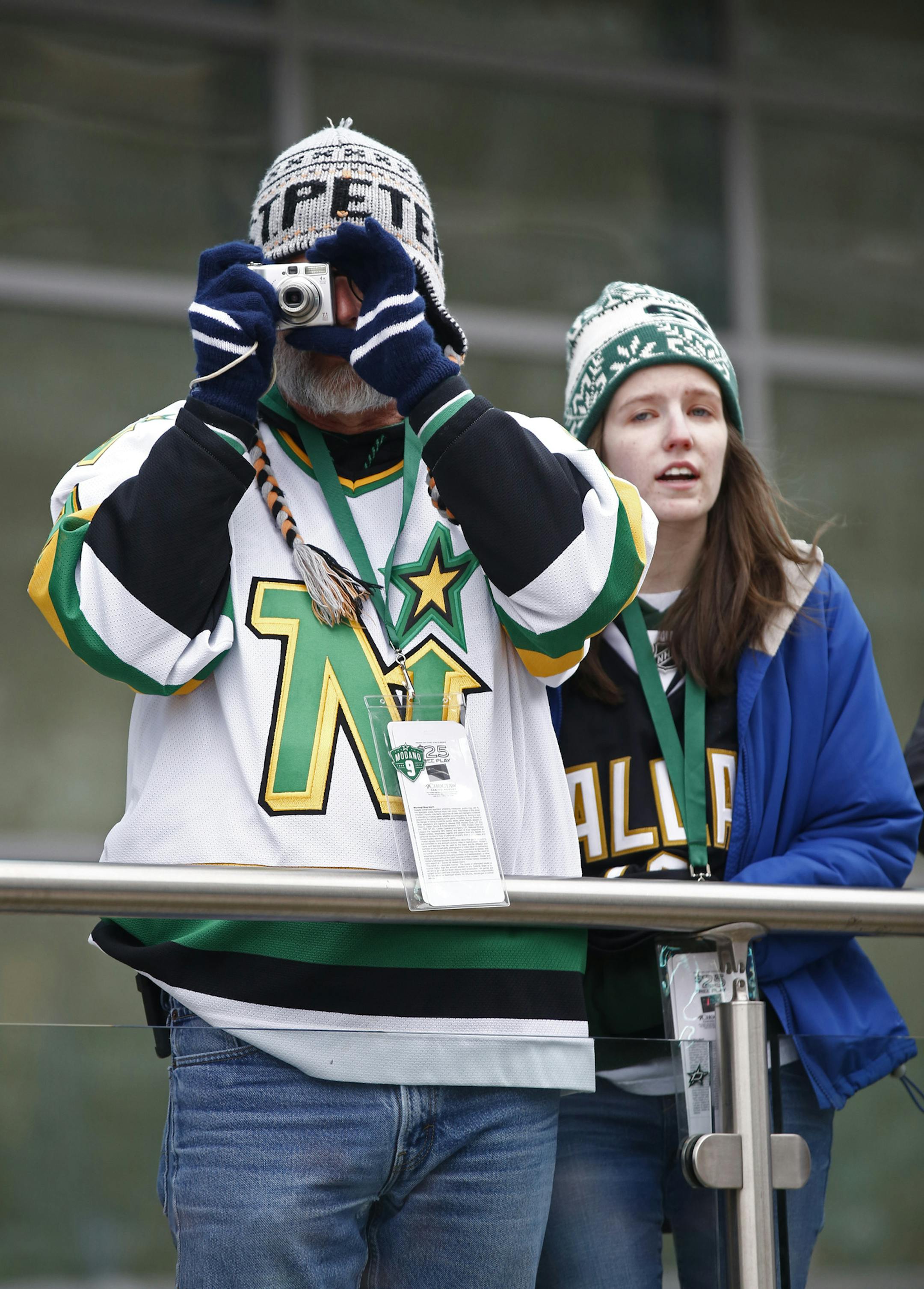 Dallas Stars fans Trey Adair and Brianna Adair watch the green carpet entrance in the plaza before the Mike Modano jersey retirement ceremony before the NHL hockey game between the Stars and the Minnesota Wild on Saturday, March 8, 2014, in Dallas. (AP Photo/The Dallas Morning News, Nathan Hunsinger) MANDATORY CREDIT; MAGS OUT; TV OUT; INTERNET USE BY AP MEMBERS ONLY; NO SALES