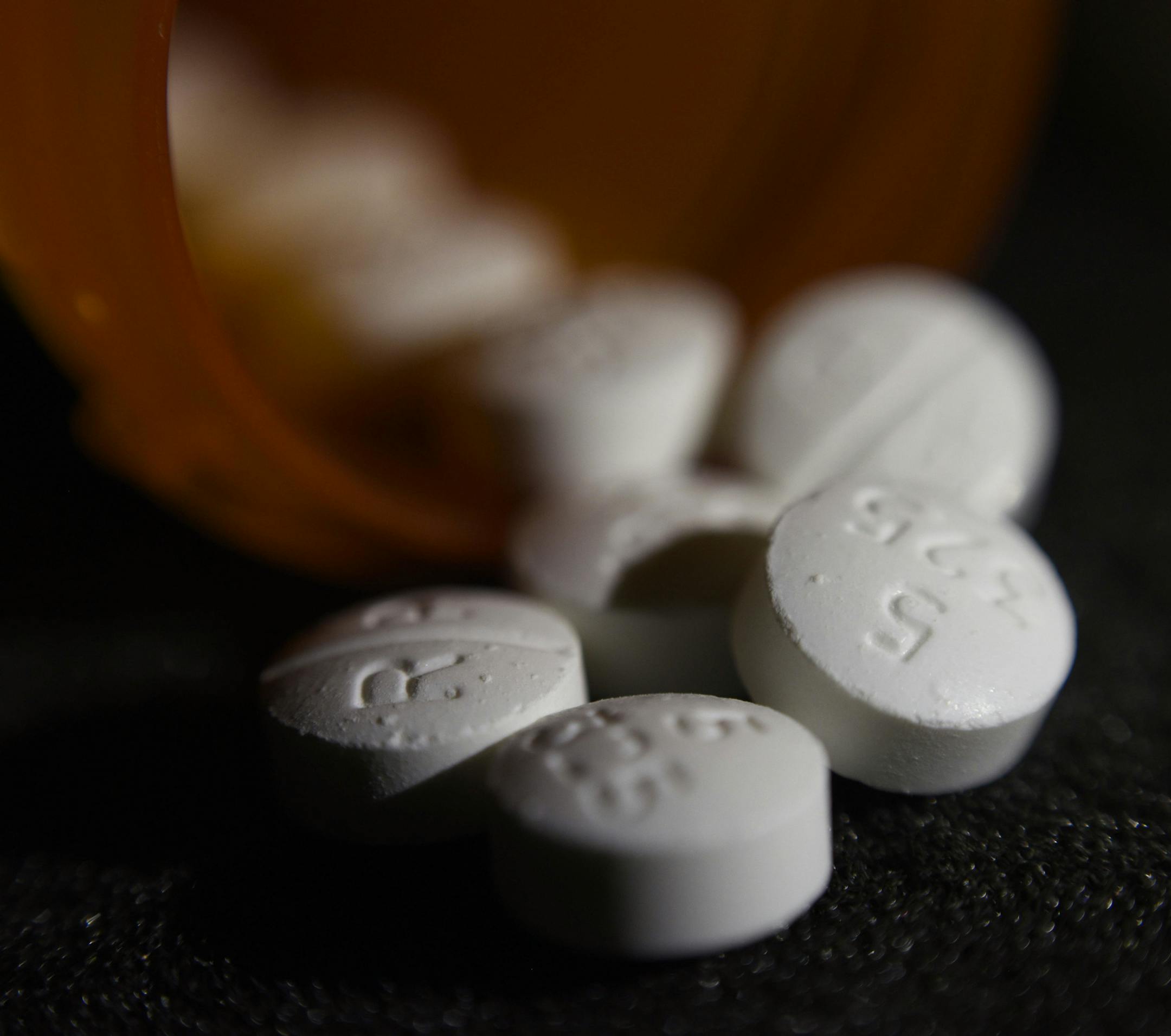 FILE - This Tuesday, Aug. 15, 2017 file photo shows an arrangement of pills of the opioid oxycodone-acetaminophen in New York. In an innovative experiment, doctors prescribed fewer opioids after learning of their patient's overdose death in a letter from a county medical examiner. More than 400 “Dear Doctor” letters, sent in 2017 in San Diego County, were part of a study that put a human face on the U.S. opioid crisis for many doctors. (AP Photo/Patrick Sison) ORG XMIT: NY635