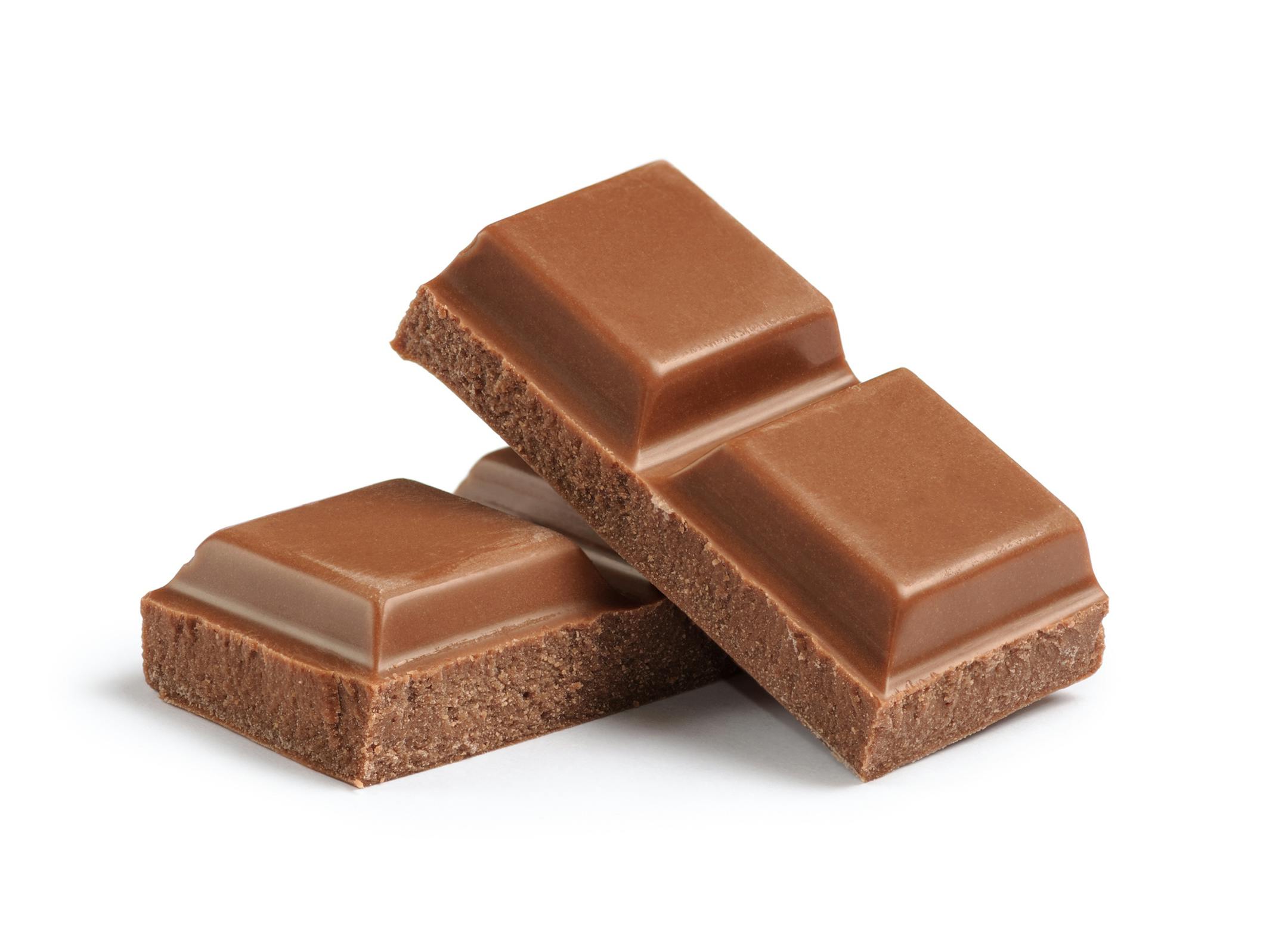 Cubes of milk chocolate bar isolated on white background