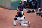 San Francisco Giants' manager Gabe Kapler kneels during the national anthem prior to an exhibition game against the Oakland Athletics